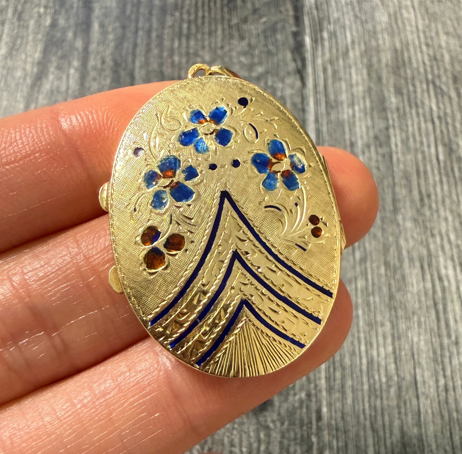 Large Enamel and 14K Gold "Forget Me Not" Locket: Metal: 14K Yellow GoldWeight: 8.4 gramsMeasurements: 1.5 inches long by 1.1 inches wideMarkings: "14K"Condition: In good condition with some enamel loss and minor surface wear consistent with age.Foll