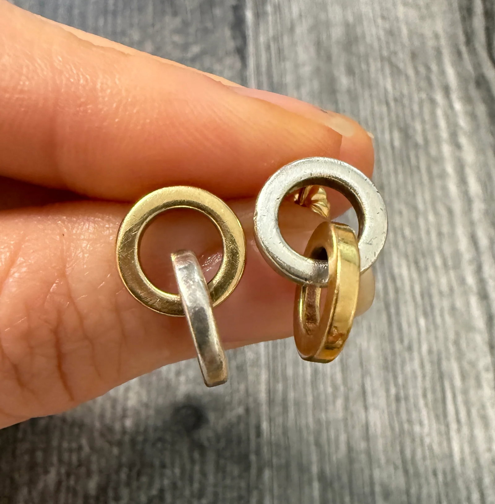 Tiffany & Co Interlocking Circle Link Dangle Earrings in Silver and 18K Gold: Metal: 18K Yellow Gold and Sterling SilverWeight: 6.8 gramsMeasurements: 0.75 inches long Markings: "Tiffany & Co 925 750 ITALY"Condition: In good condition with some minor surface wearFollow us on In