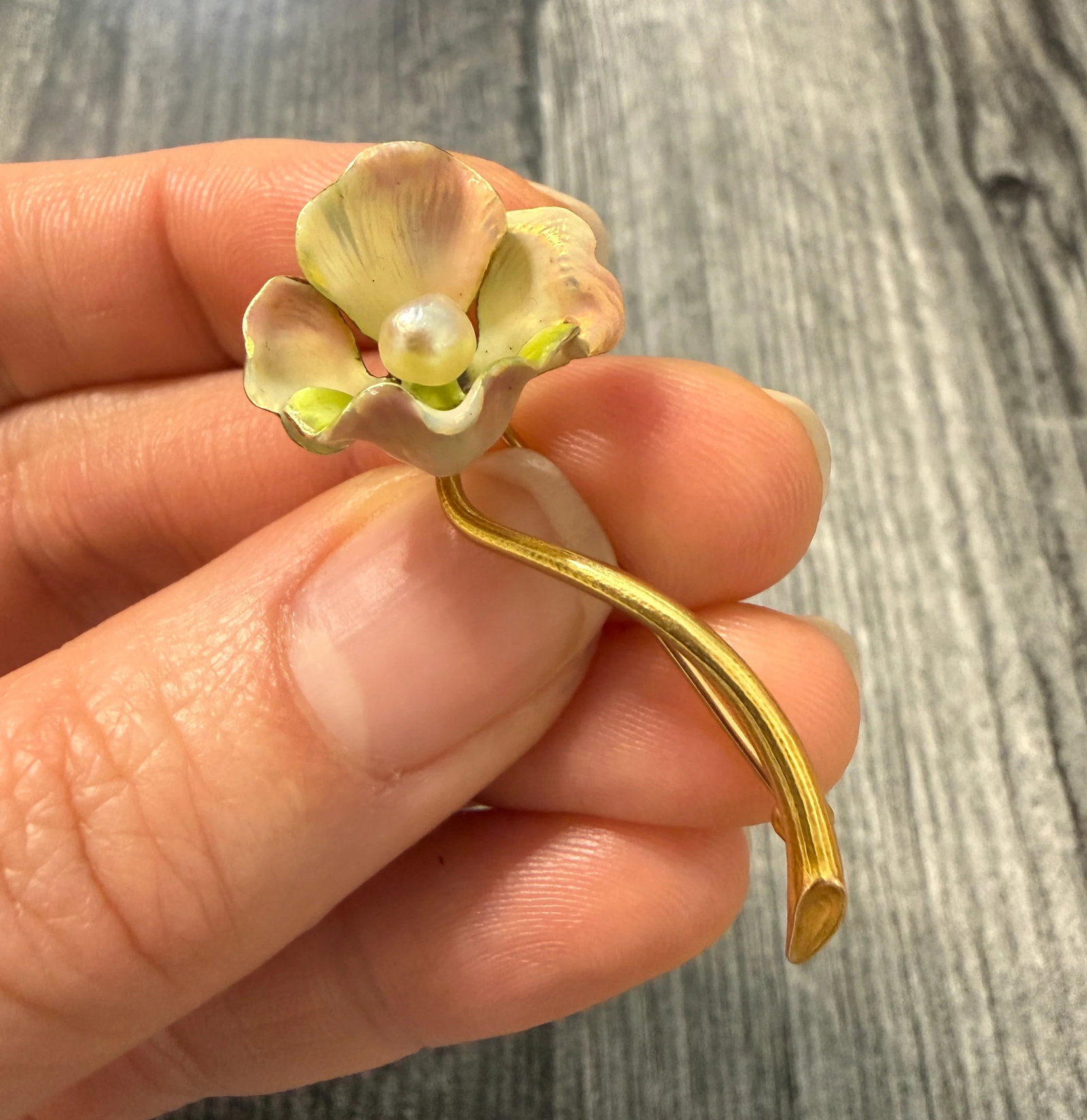 Art Nouveau Whiteside and Blank Iridescent Enamel Flower Pin: Metal: 14K Yellow Gold Weight: 4.4 gramsPearl: 4.3 mm diameterMeasurements: 0.75 inches long by 1.75 inches wideMarkings: "14K" and maker's markCondition: In very good condition with some minor surfac