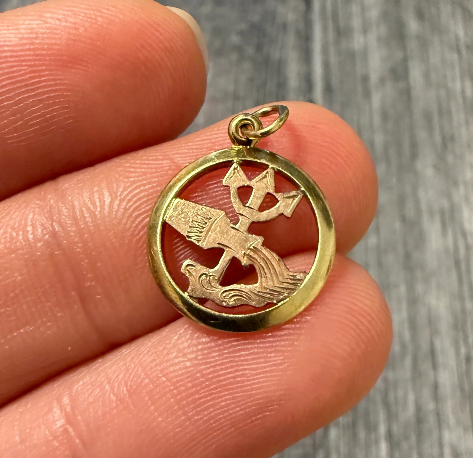 Mini Zodiac Aquarius Charm in 18K Gold: Metal: 18K Yellow and Rose Gold Weight: 0.9 gramsMeasurements: 0.5 inch diameter Markings: "18" with hallmarksCondition: In good condition with some minor surface wearFollow us on Instagram @alphaomeg