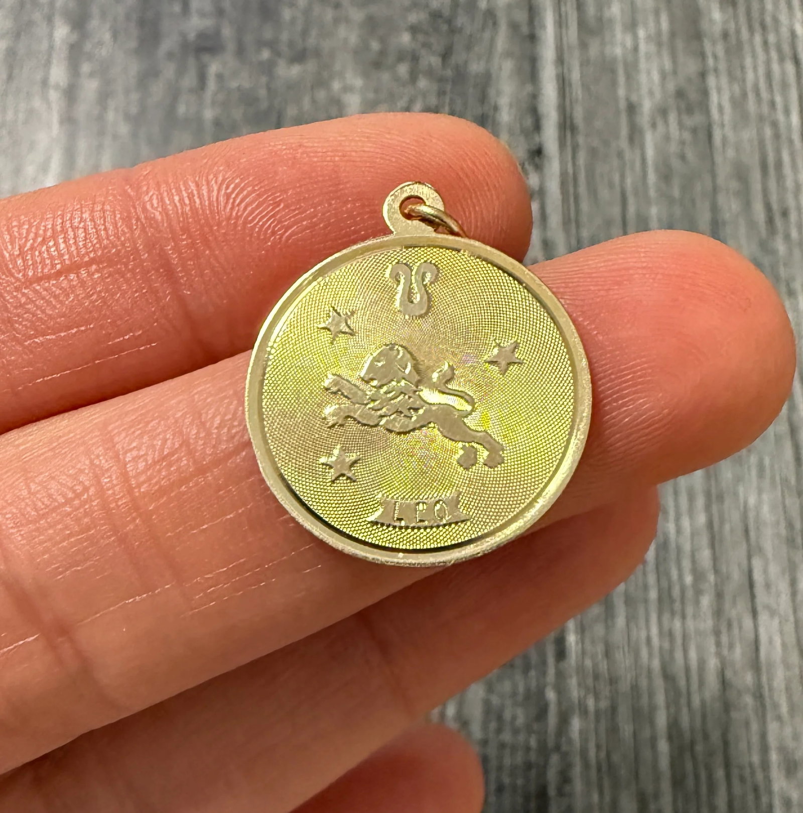 Leo Zodiac 14K Gold Charm: Metal: 14K Yellow Gold Weight: 1.5 gramsMeasurements: 0.75 inches diameterMarkings: "TC14K"Condition: In good condition with some minor surface wearFollow us on Instagram @alphaomegajewelry for the la