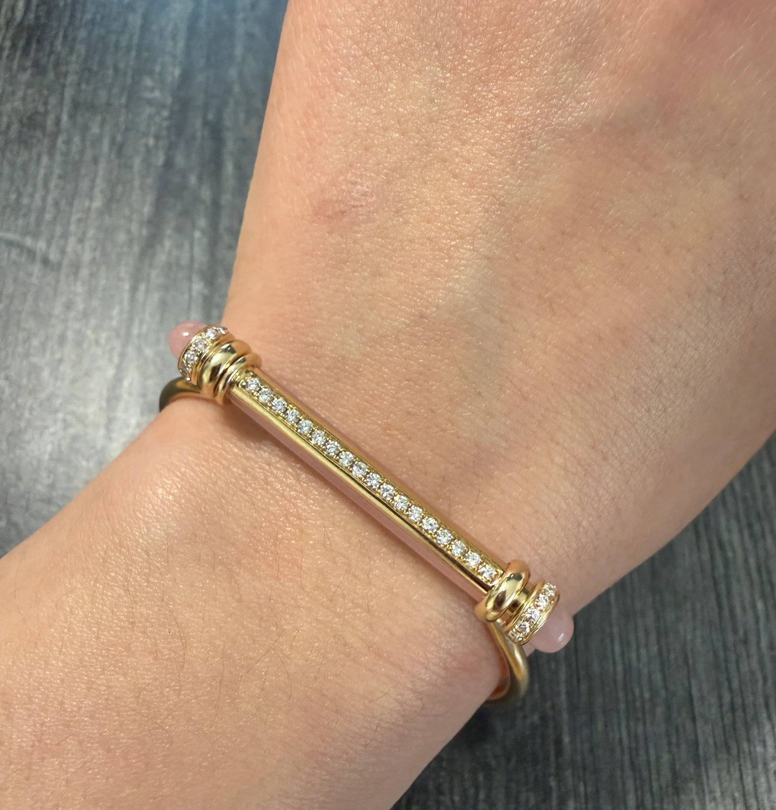 Elongated Rose Quartz Bar and Diamond Bangle in 14K Gold: Metal: 14K Yellow Gold Weight: 11.3 gramsInner circumference: 6.5 inches aroundInner diameter: 1.75 inches long by 2.15 inches wideDiamonds: Approximately 1.1 caratsMarkings: "14K 585"Condition: The b