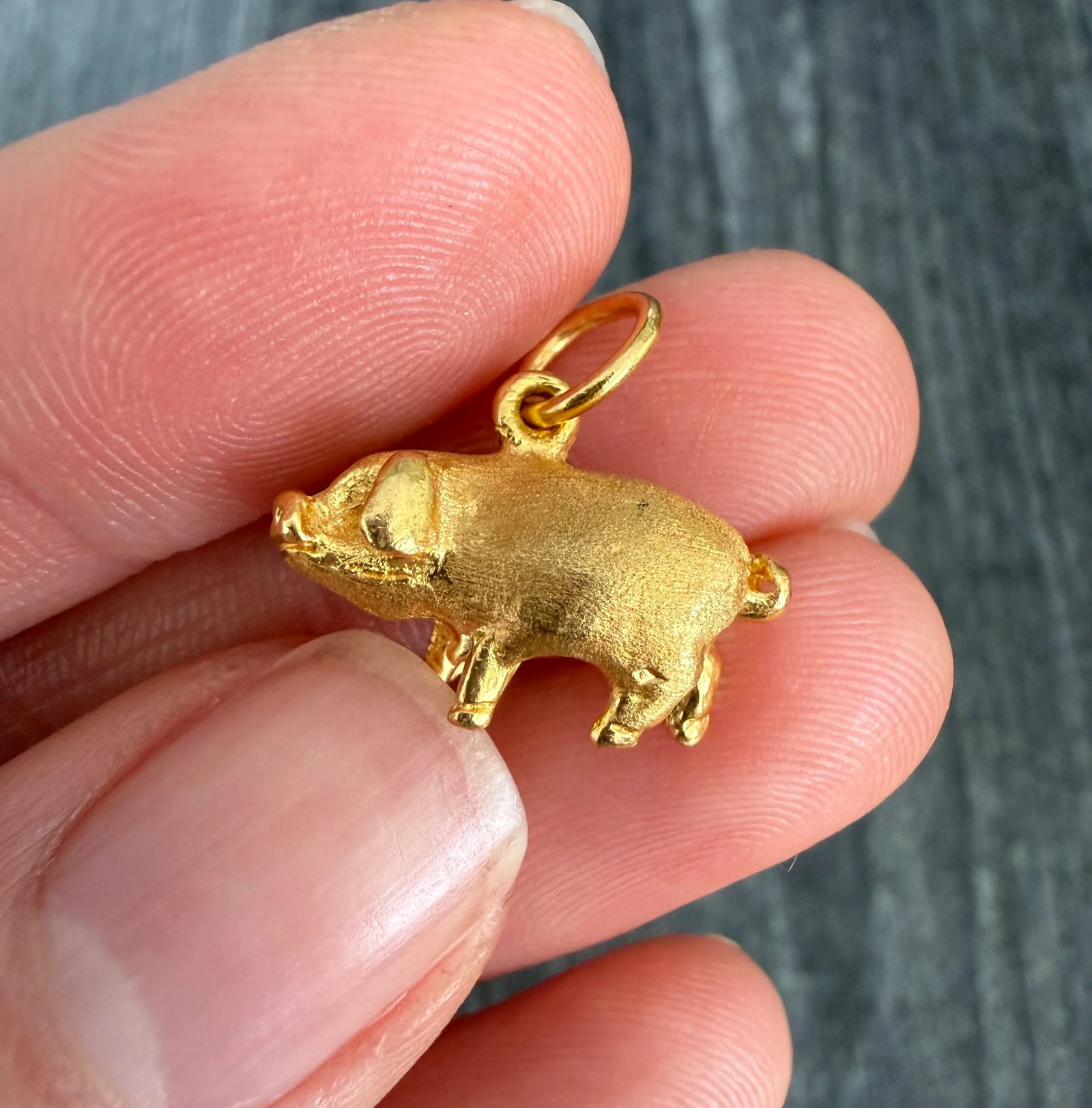 22K Gold Pig Charm: Metal: 22K Yellow Gold Weight: 6.6 gramsMeasurements: 0.35 inches long by 0.75 inches wideMarkings: "916"Condition: In very good condition with some minor surface wear.Follow us on Instagram @alphaome