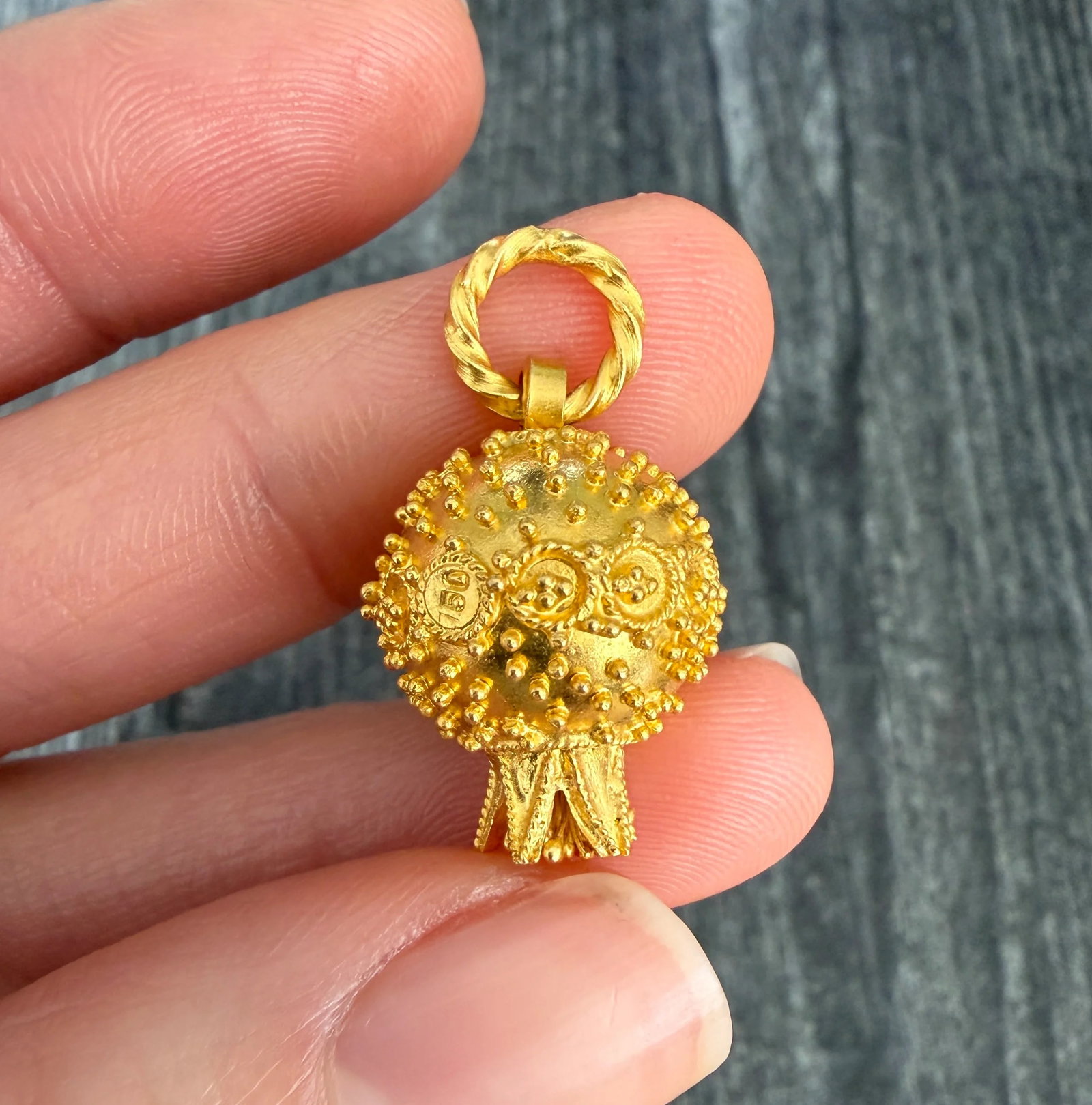 Midsized Etruscan Revival Style Pomegranate Charm in 18K Gold: Metal: 18K Yellow Gold Weight: 5.5 gramsMeasurements: 0.75 inches long by 0.65 inches wide Condition: In very good condition with some minor surface wear.Follow us on Instagram @alphaomegajewelry for 