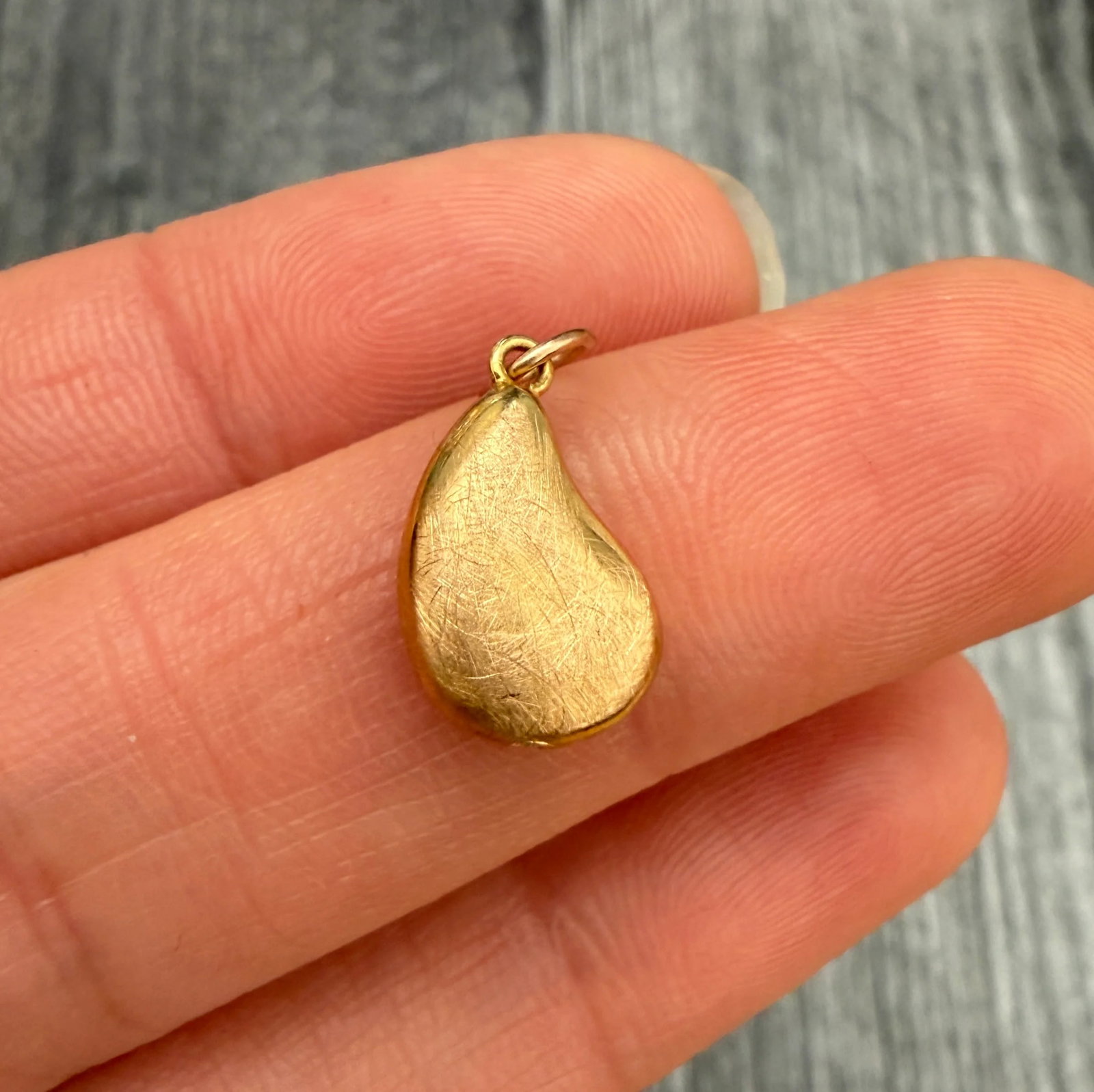 14K Gold Bean Shaped Charm: Metal: 14K Yellow Gold (Acid Tested)Weight: 0.6 gramsMeasurements: 0.5 inches long by 0.3 inches wideMarkings: NoneCondition: In very good condition with some minor surface wear.Follow us on Instagram