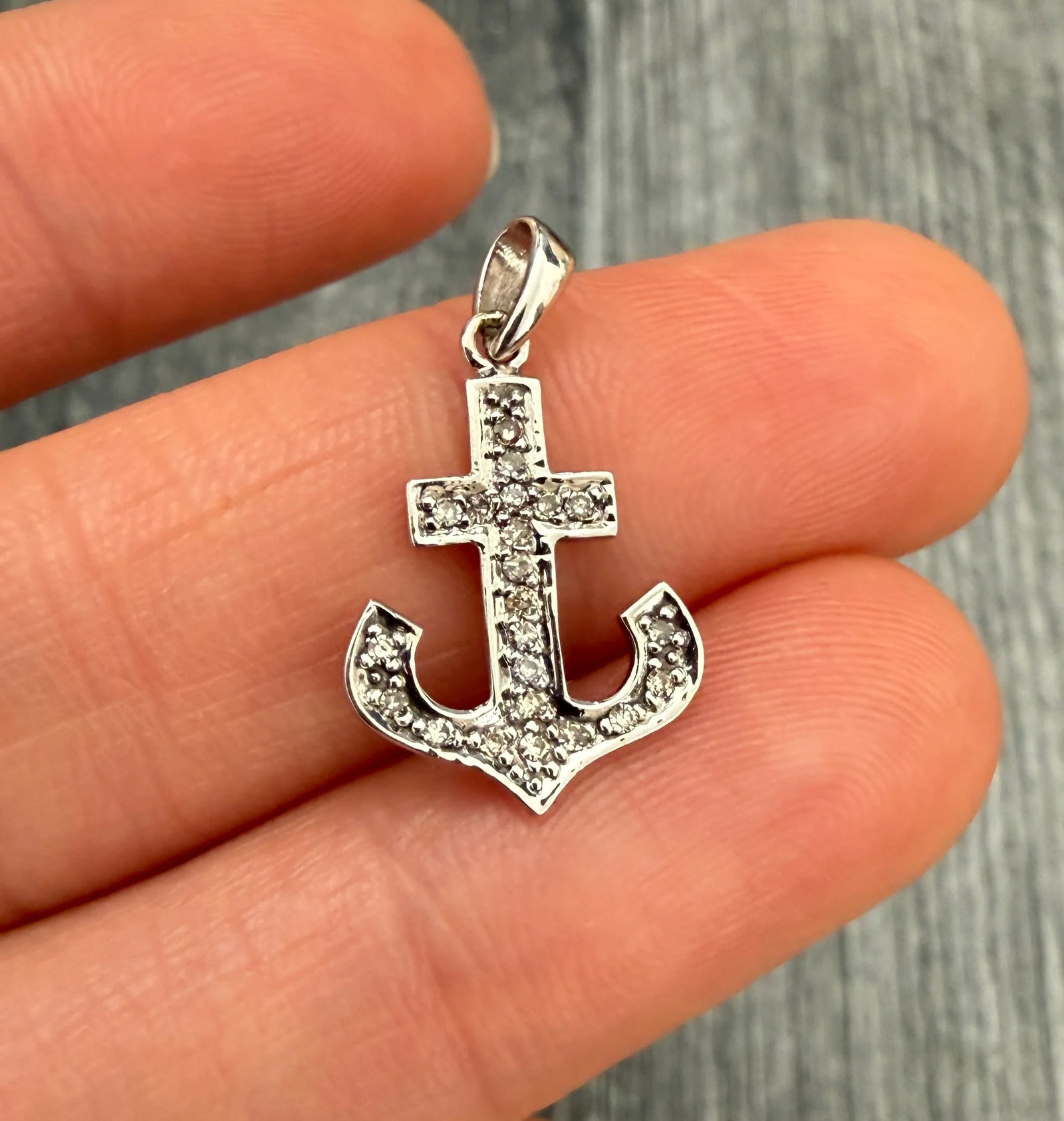 Diamond Anchor Charm in 14K Gold: Metal: 14K White Gold Weight: 1 gramMeasurements: 0.75 inches long by 0.55 inches Markings: "14K"Condition: In very good condition with some minor surface wear.Follow us on Instagram @alphaomegajewelr