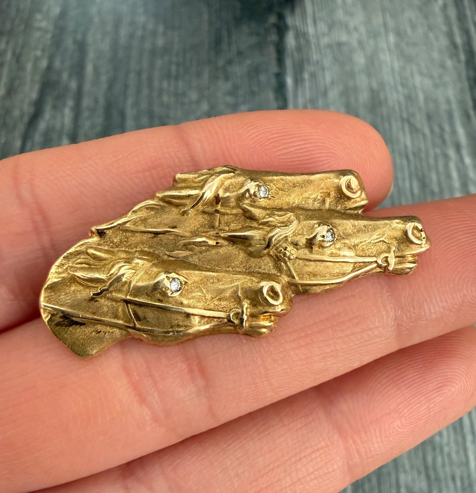 Vintage 14K Gold Equestrian Brooch of Three Racing Horses: Metal: 14K Yellow Gold Weight: 6.1 gramsMeasurements: 0.75 inches long by 1.55 inches wideMarkings: "14K"Condition: In very good vintage condition with some minor surface wear consistent with age.Foll