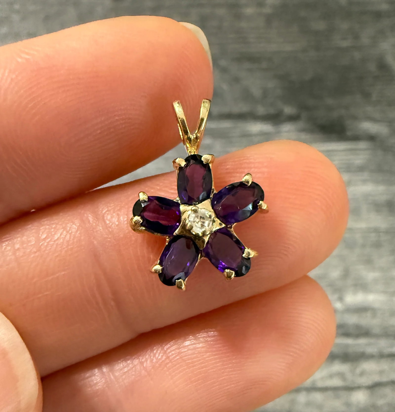 Amethyst and Diamond Flower Charm in 14K Gold: Metal: 14K Yellow Gold Weight: 1.7 gramsMeasurements: 0.5 inches long by 0.5 inches wideMarkings: "14K"Condition: In very good condition with some minor surface wear.Follow us on Instagram @alphaomega