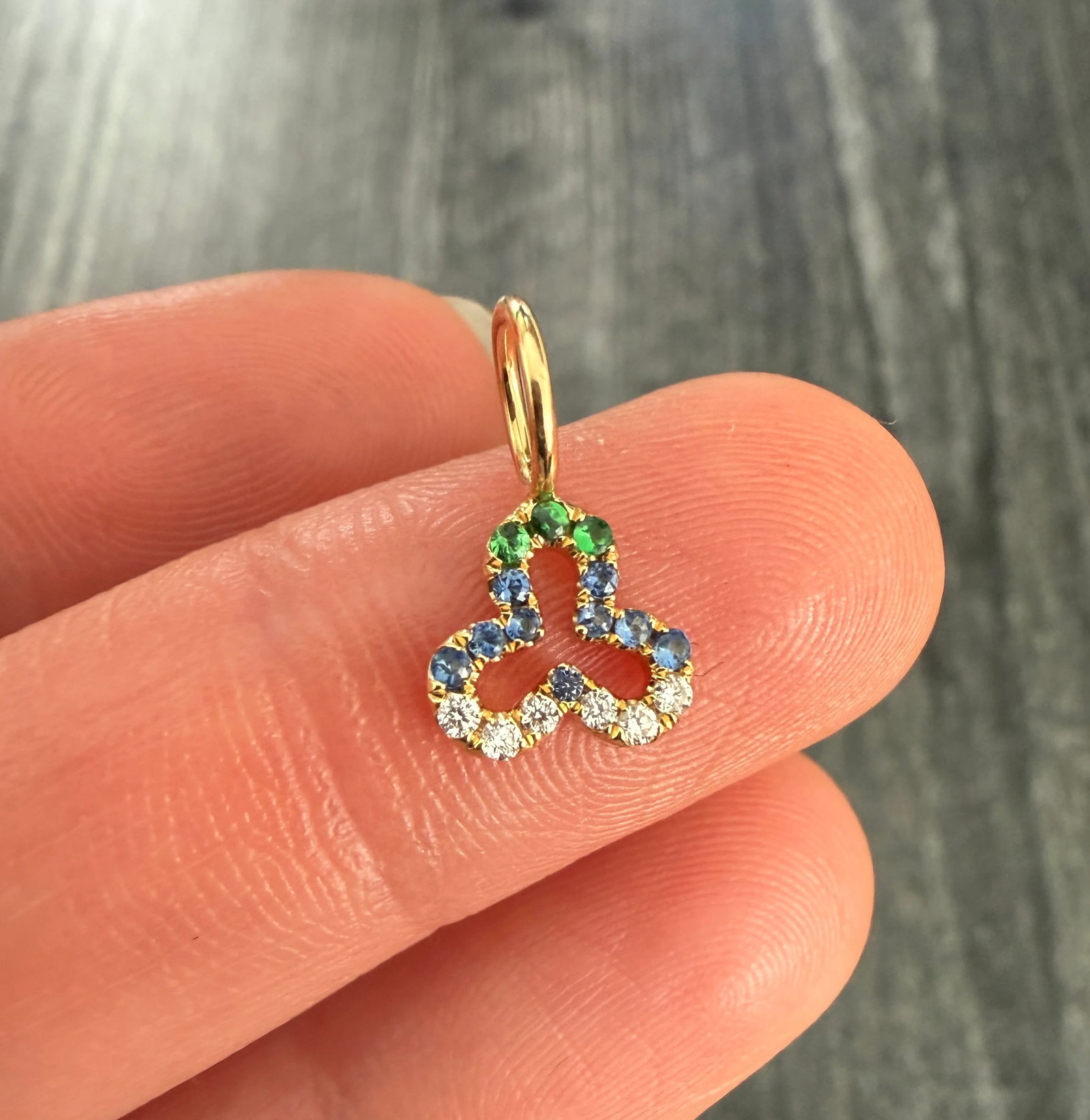 Devon Woodhill Sapphire and Diamond Trefoil Charm: Metal: 18K Yellow Gold Weight: 0.8 gramsDiamonds and Sapphires: Approx 0.05 ctsMeasurements: 0.3 inches long by 0.3" wideMarkings: "DW 750"Condition: In very good condition with some minor surface wea