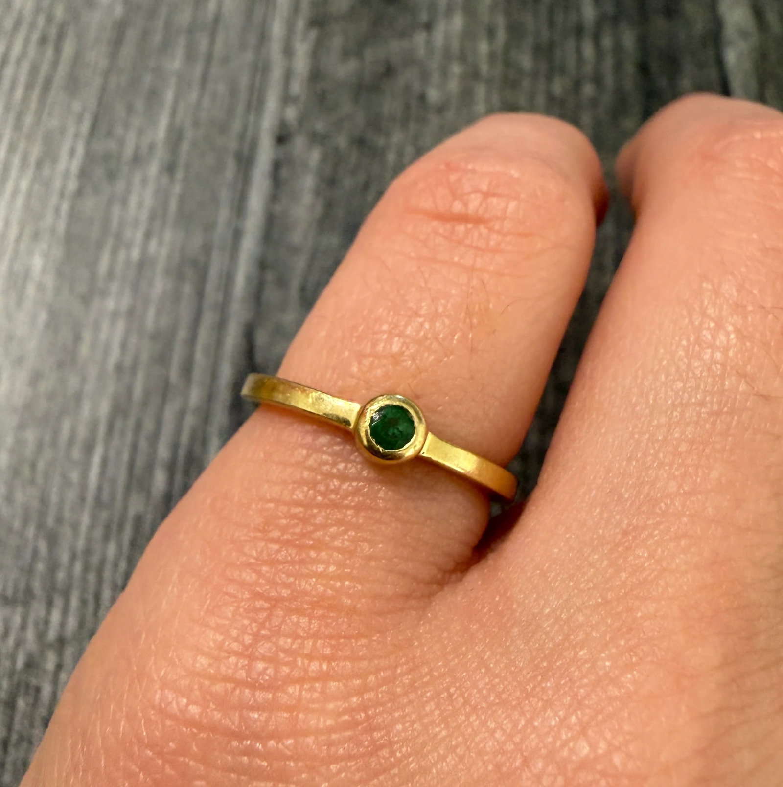 Vintage Gucci Emerald and 18K Gold Ring: Metal: 18K Yellow GoldWeight: 2.3 gramsEmerald: Approximately 0.10 caratsRing Size: 5 (slightly resizable)Width: 4 mm wideMarkings: "Gucci 750 18Kt"Condition: Both the emerald and the gold shows surfa