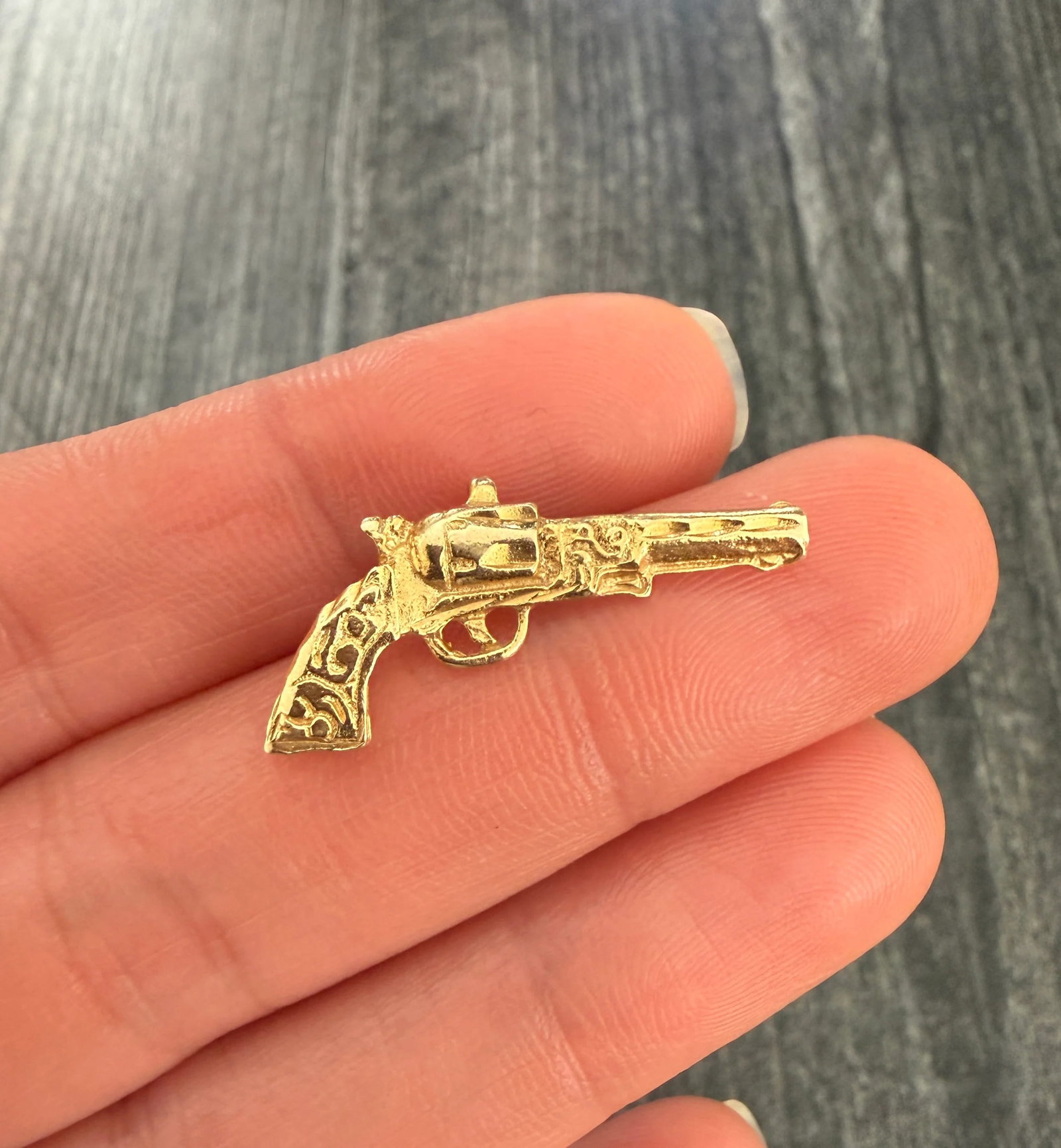 Vintage 14K Gold Pistol Charm: Metal: 14K Yellow Gold Weight: 1.6 gramsMeasurements: 0.5 inches long by 1.1 inches wideMarkings: "14K"Condition: In very good condition with some minor surface wear. Follow us on Instagram @alphaomeg