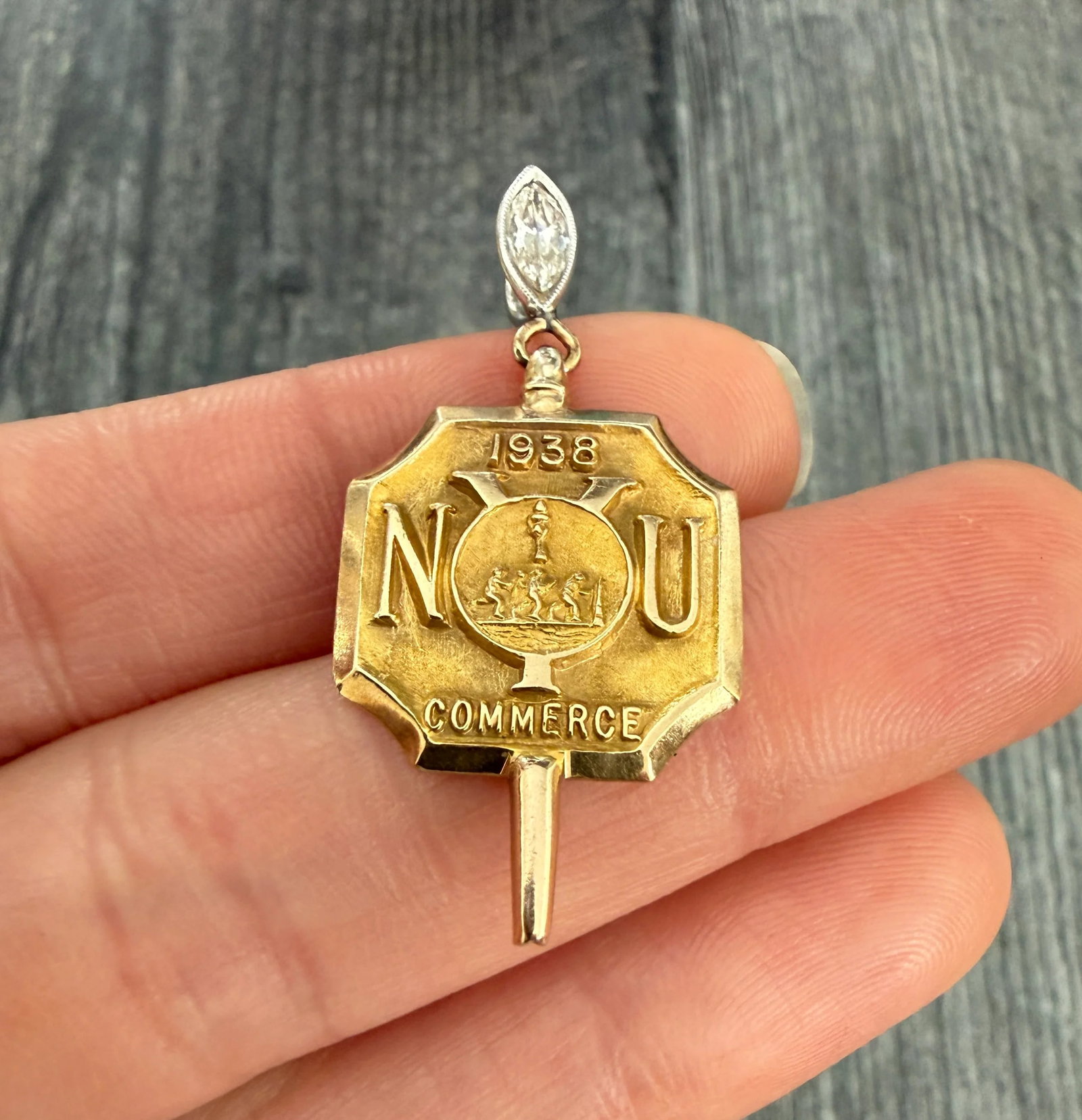 Vintage "NYU 1938" 14K Gold Watch Key Pendant with Diamond Bale: Metal: 14K Yellow GoldWeight: 4.8 grams Diamond: Approximately 0.35 caratsMeasurements: 1.5 inches long by 0.75 inches wideMarkings: "14K"Condition: In very good condition with some minor surface wear