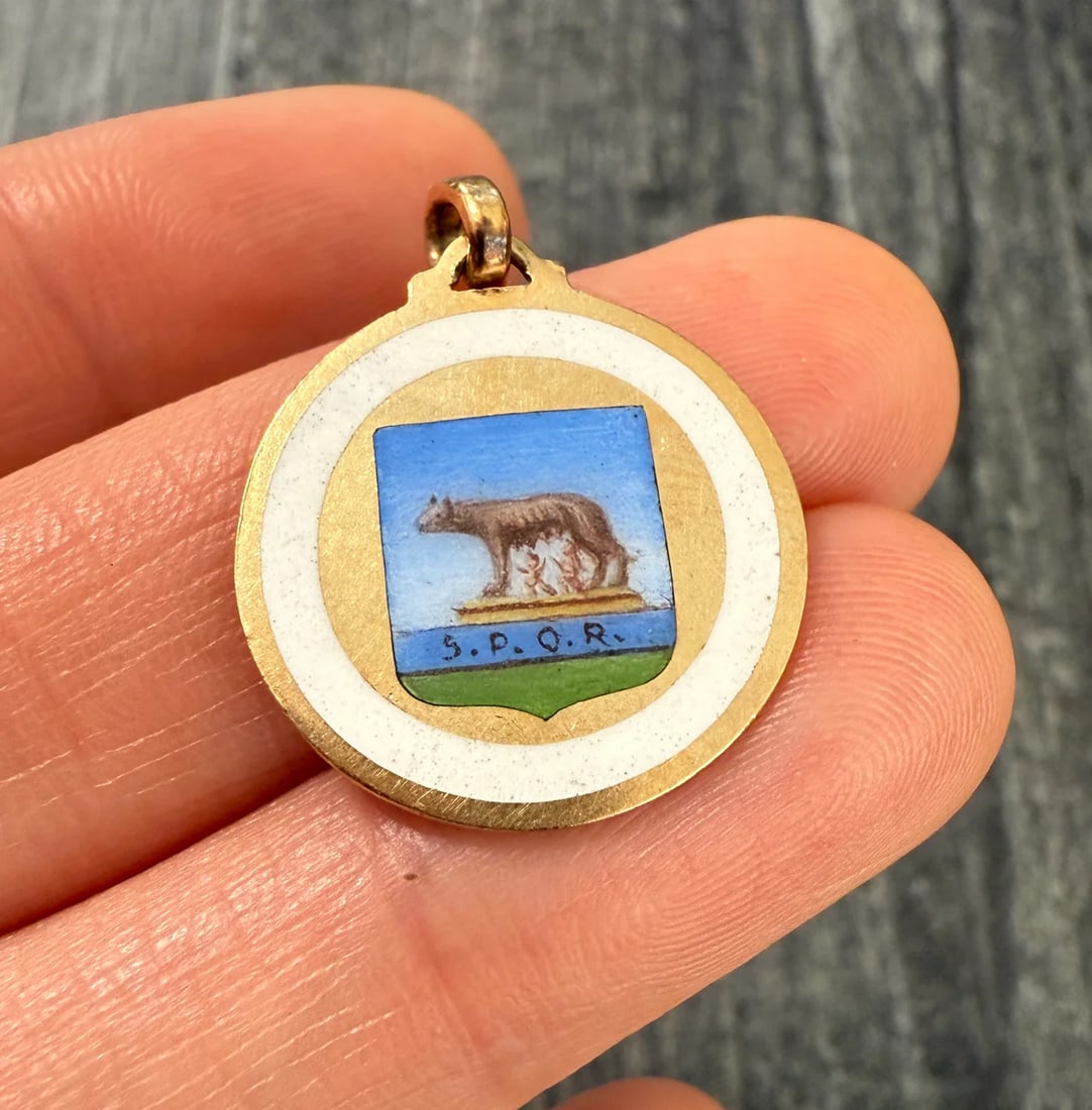 Enameled 18K Gold Capitoline Wolf Charm of Rome: Metal: 18K Yellow Gold (bale is not gold)Weight: 3.9 gramsMeasurements: 0.8 inches diameterMarkings: "750"Condition: In very good condition with some minor surface wear consistent with age. Follow us 