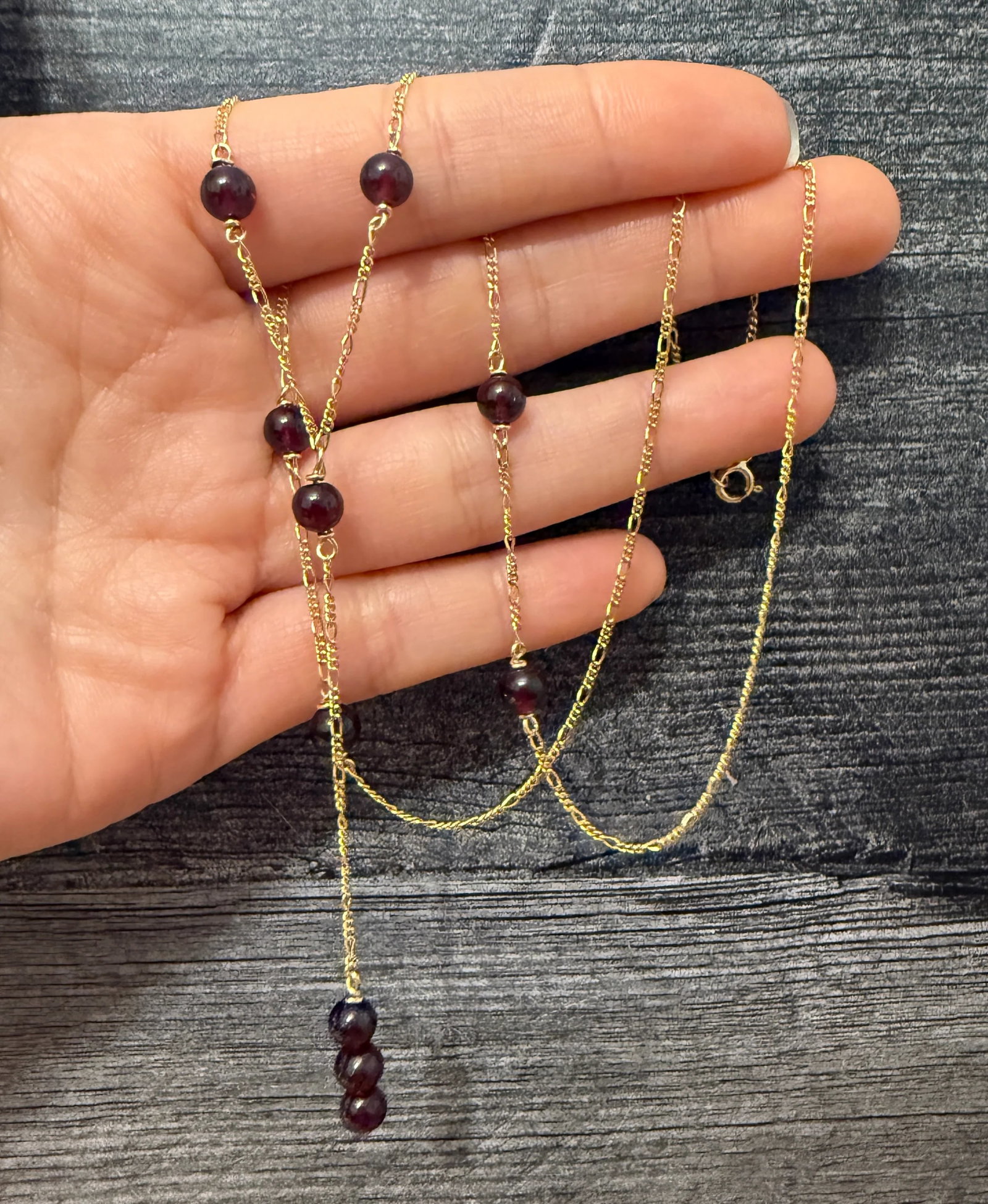 Vintage Garnet Bead Lariat Necklace in 14K Gold: Metal: 14K Yellow Gold Weight: 9.4 gramsMeasurements: 23 inches long (wearable length)Garnet: 5.7 mm diameter eachMarkings: "14K ITALY MILOR"Condition: In very good condition with some minor surface w