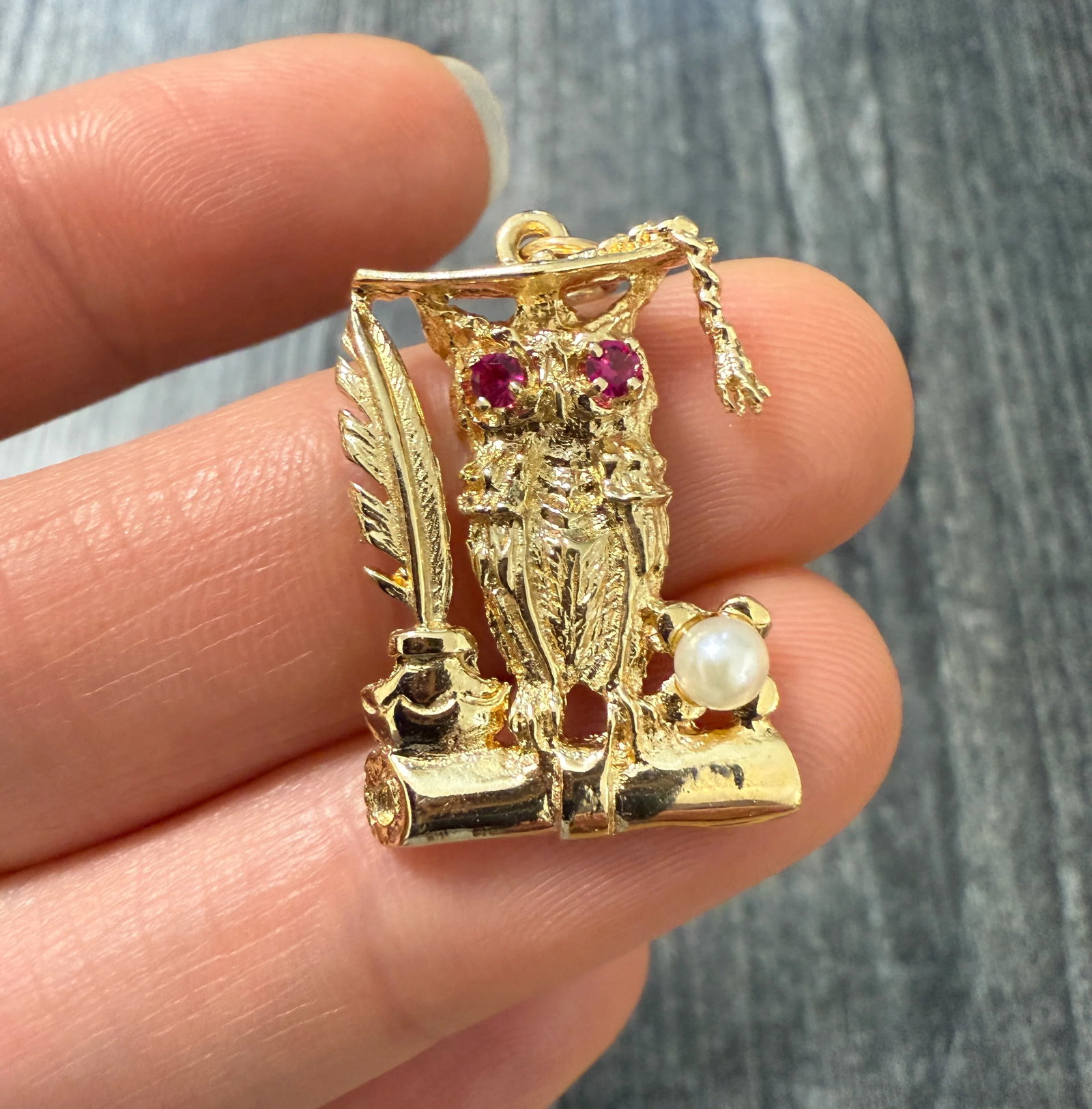 Vintage 14K Gold Owl and Quill Graduation Pendant: A vintage 14K gold owl and quill graduate charm. It's perfect for the lifelong learner as well. Metal: 14K Yellow Gold Weight: 3.9 gramsPearl: 3.6 mmMeasurements: 0.95 inches long by 0.7 inches wideMa