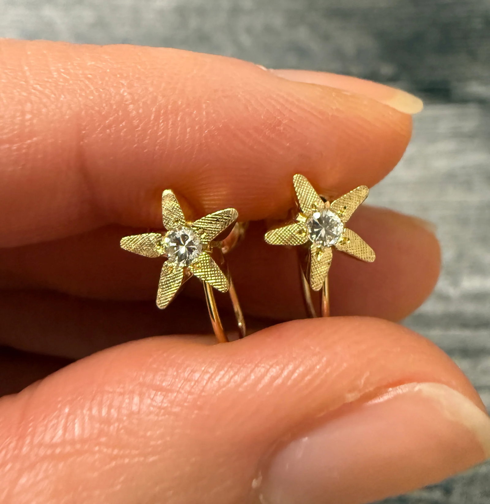 Vintage Diamond and 14K Gold Star Flower Unpierced Screwback Earrings: Metal: 14K GoldWeight: 2 gramsMeasurements: 0.3 inches diameter flowerDiamonds: Approximately 0.10 carats Markings: NoneCondition: In very good condition with some minor surface wear consistent with a