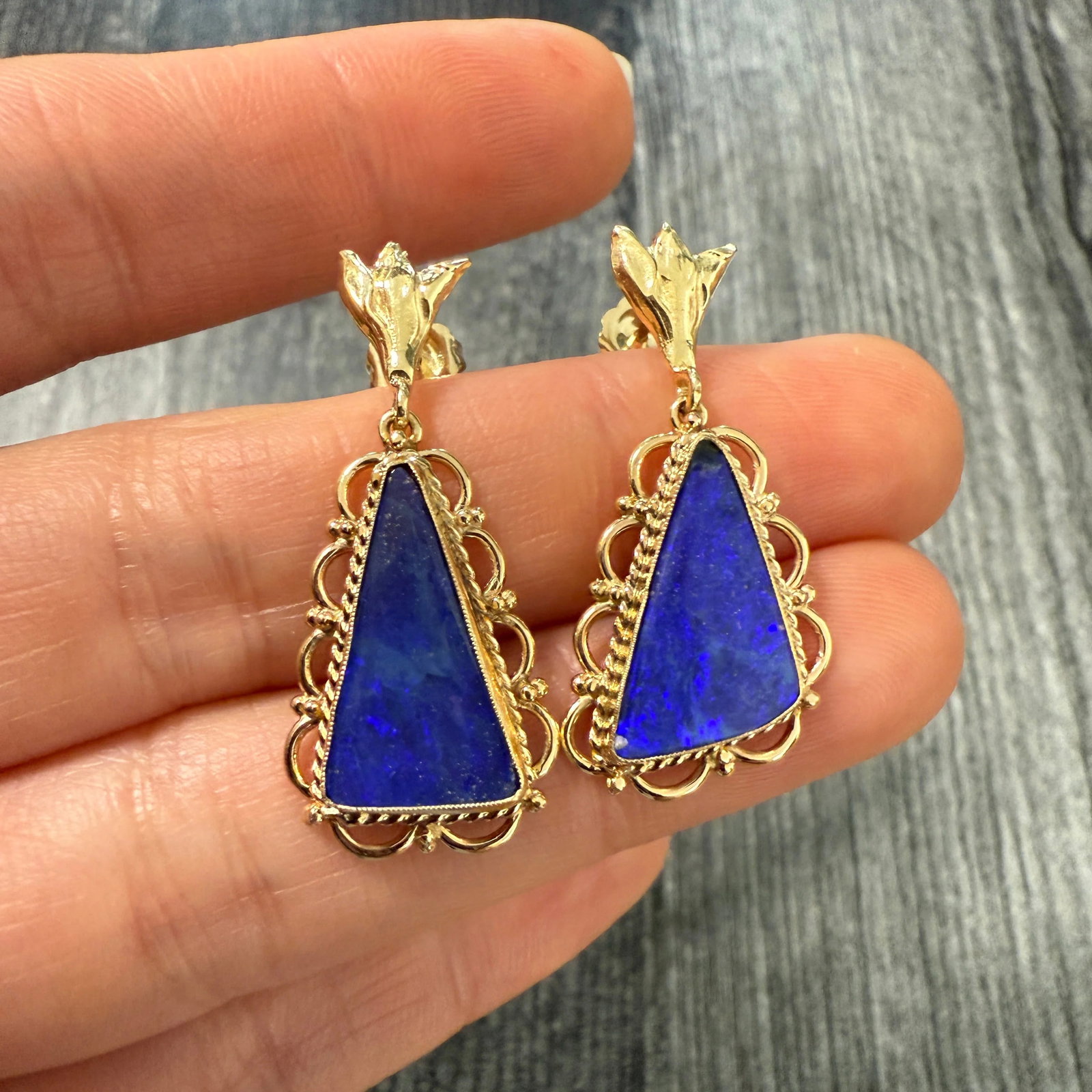 Carved Blue Boulder Opal and 14K Gold Earrings: Metal: 14K Yellow Gold Weight: 5.7 gramsMeasurements: 1.65 inches by 0.6 inches wide Markings: "14K"Condition: In good condition with a chip in one opal that blends in well. Follow us on Instagram @al