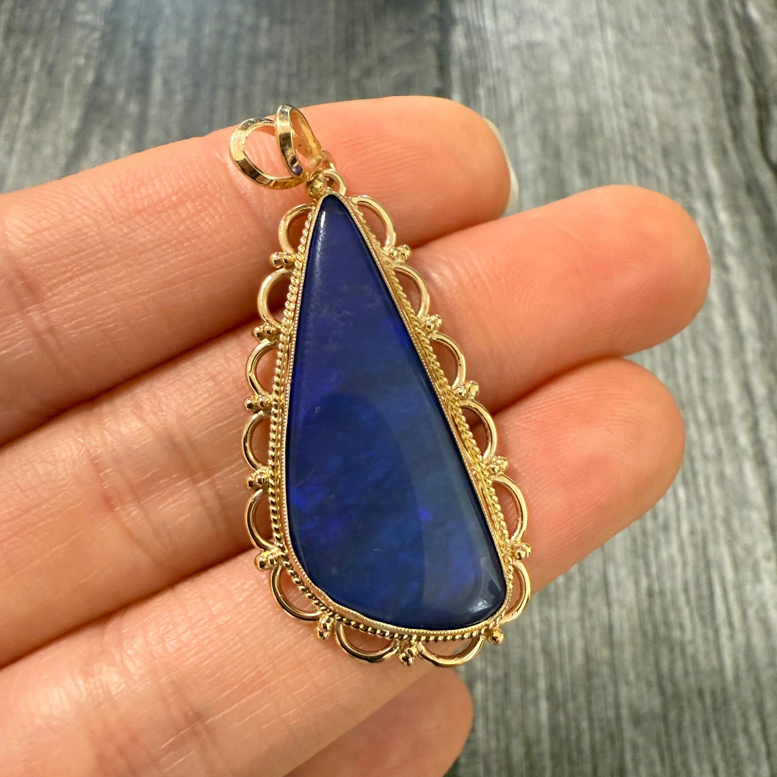 Carved Blue Boulder Opal and 14K Gold Pendant: Metal: 14K Yellow Gold Weight: 6.3 gramsMeasurements: 1.5 inches long by 0.8 inches wideMarkings: "14K"Condition: In very good condition with some minor surface wear consistent with age. Follow us on 