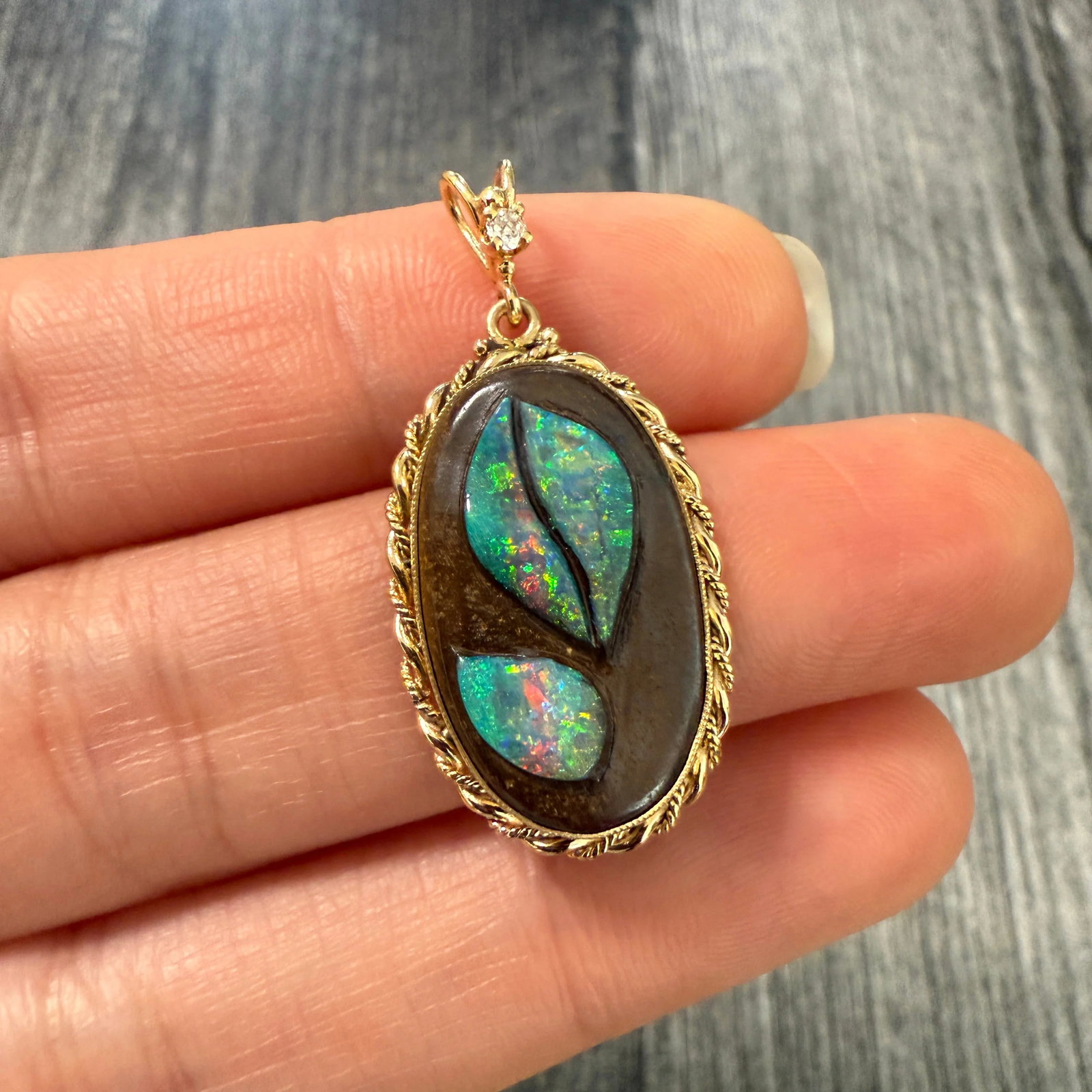 Handcarved Carved Boulder Opal Leaf Pendant in 14K Gold: Metal: 14K Yellow Gold Weight: 3.5 gramsMeasurements: 1 inch long by 0.65 inches wideMarkings: "14K"Condition: In good condition with some minor surface wear consistent with age. Follow us on Instagra