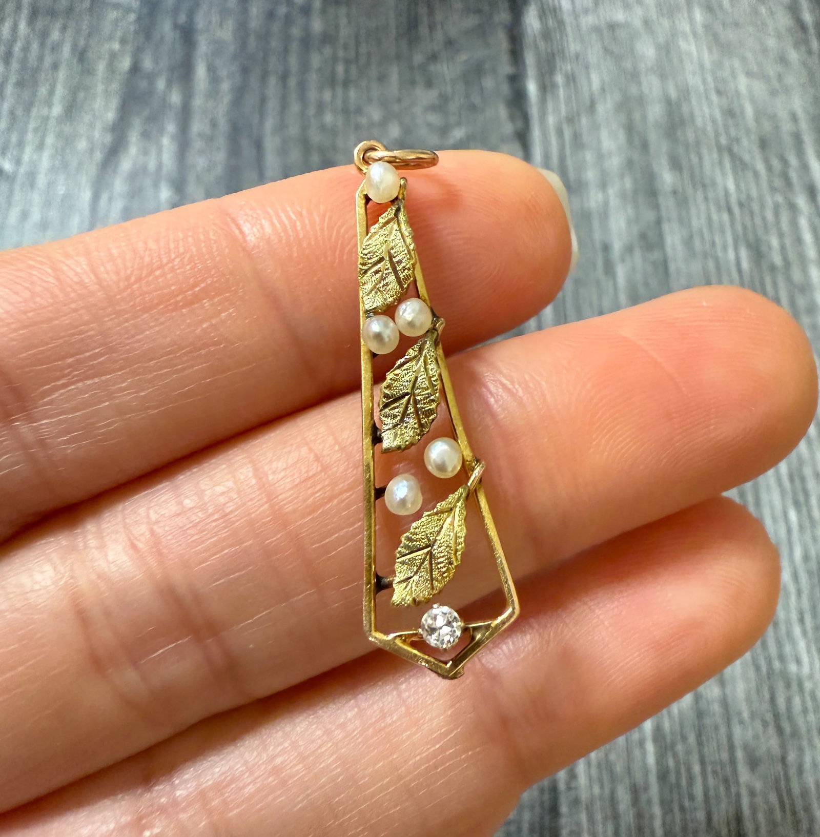 Art Nouveau Pearl and Diamond Leaf Pendant: Metal: 14K Yellow Gold (acid tested)Weight: 1.5 gramsDiamond: Approximately 0.06 ctsMeasurements: 1.3" long by 0.35" wide (at its widest point)Markings: NoneCondition: In good antique condition with s