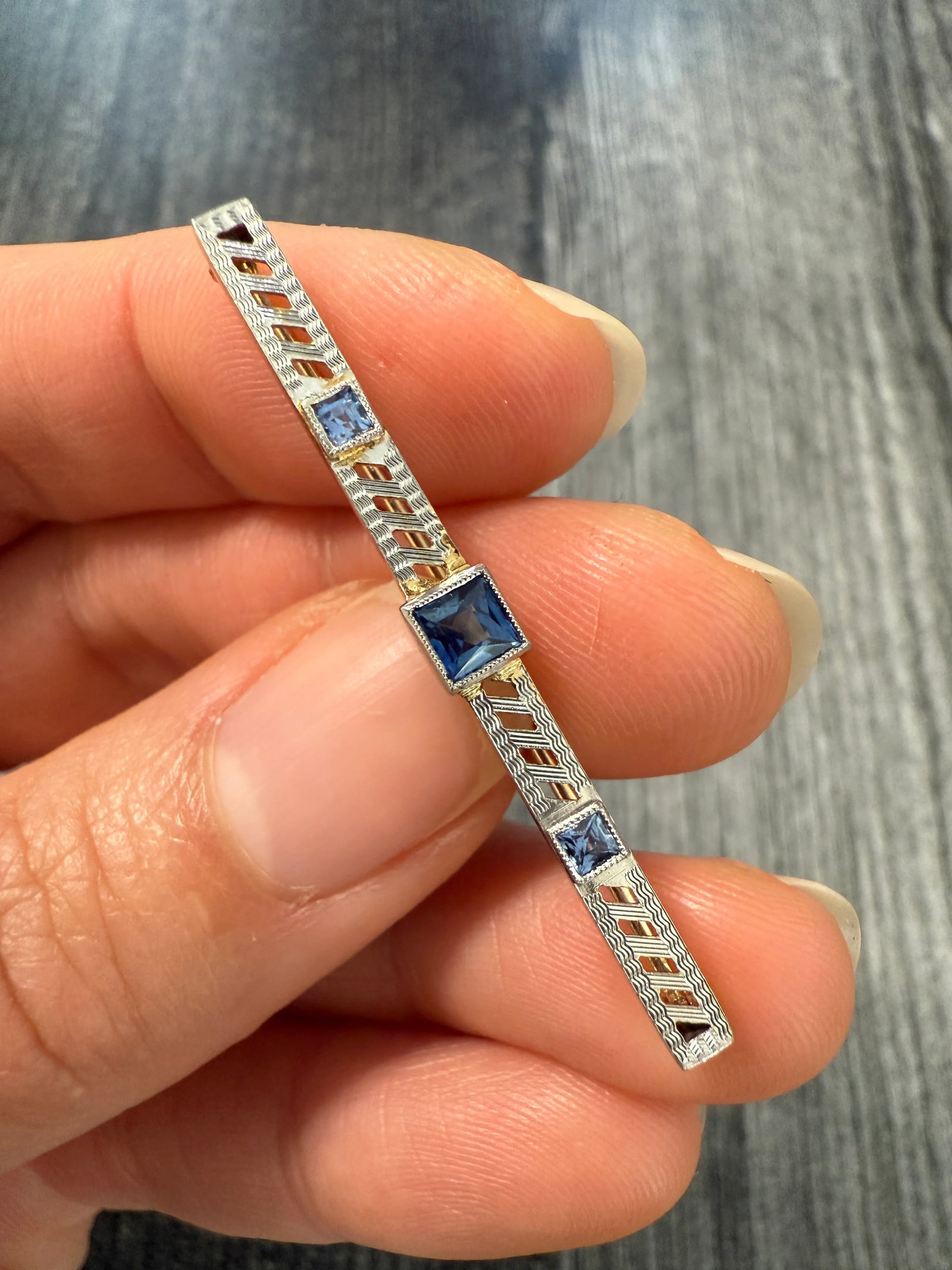 Art Deco Sapphire and 14K Gold Bar Pin: Metal: 14K Gold & White GoldWeight: 2.4 gramsMeasurements: 0.2 inches long by 1.75 inches wideMarkings: "14K" and Maker's markCondition: In very good condition with some minor surface wear consistent 