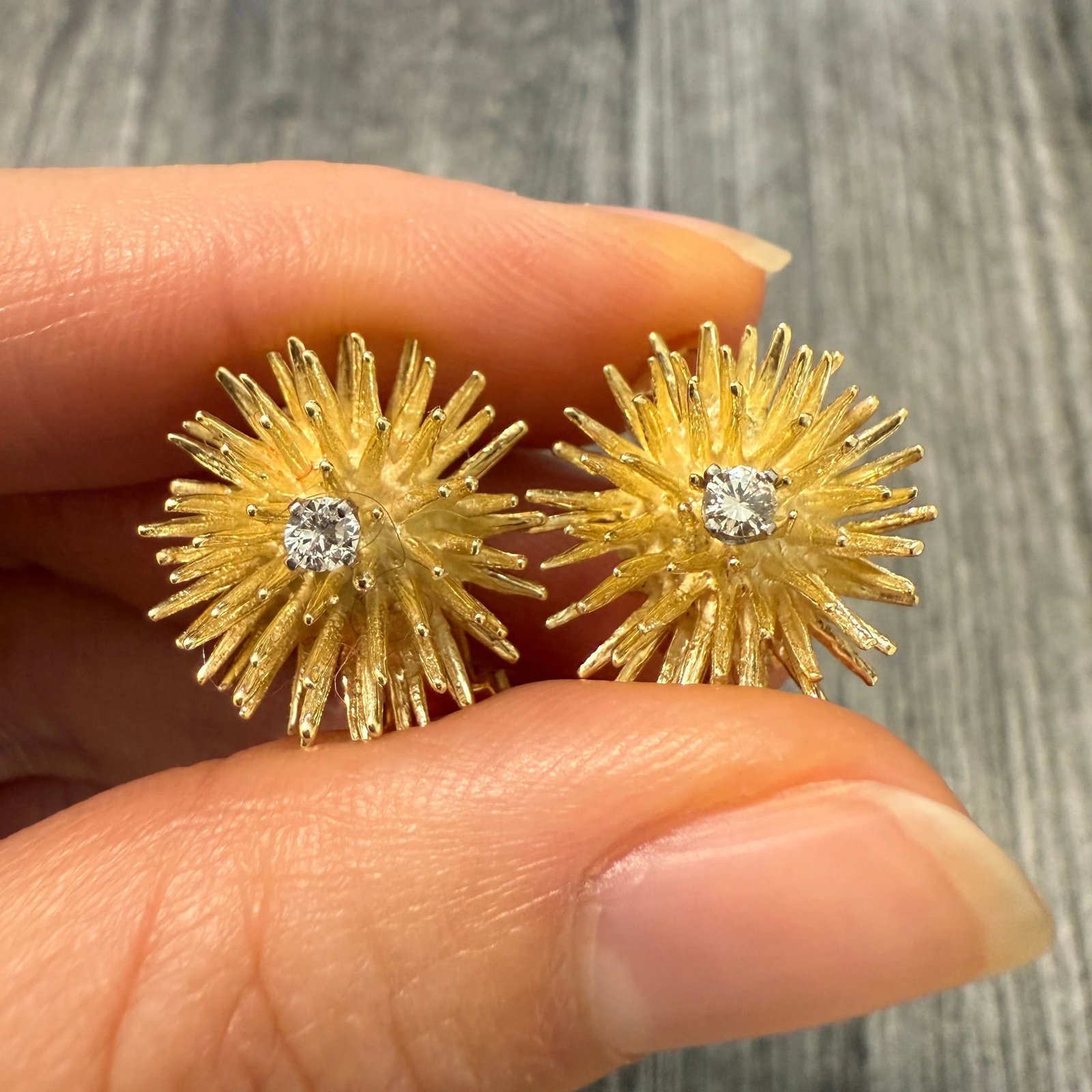 Vintage Diamond and 18K Gold Spiky Starburst Ear Clips: Metal: 18K Yellow Gold Earrings with 14K Gold Clip BacksWeight: 9.4 gramsMeasurements: 0.75 inch diameterDiamonds: Approximately 0.16 caratsMarkings: "14K"Condition: In good condition with some minor 