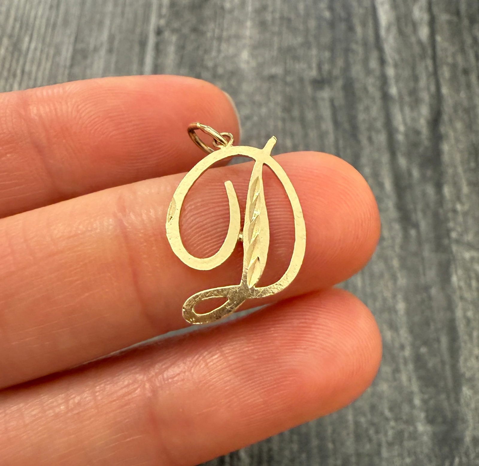 Initial "D" 14K Gold Charm: Metal: 14K Yellow Gold Weight: 0.6 gramsMeasurements: 0.65 inches long by 0.5 inches wideMarkings: "14K"Condition: In very good condition with some minor surface wear consistent with age. Follow us on
