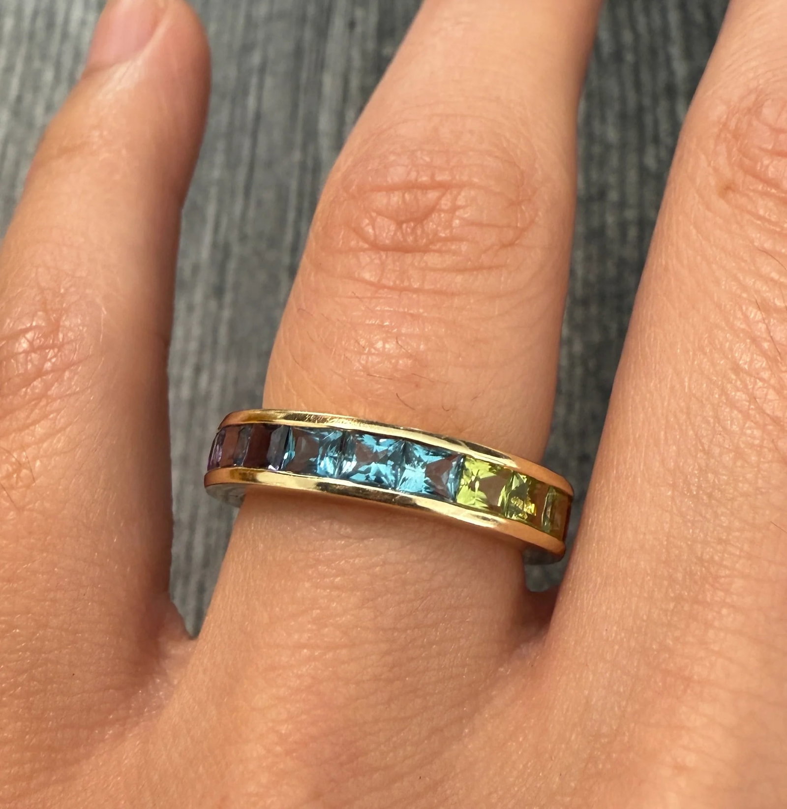 Gradient Gemstone and 14K Gold Eternity Band: Metal: 14K Yellow Gold (acid tested)Weight: 5 gramsRing Size: 6.5Width: 4.6 mm wideMarkings: “14K 585”Condition: In very good condition with some minor surface wear consistent with age.