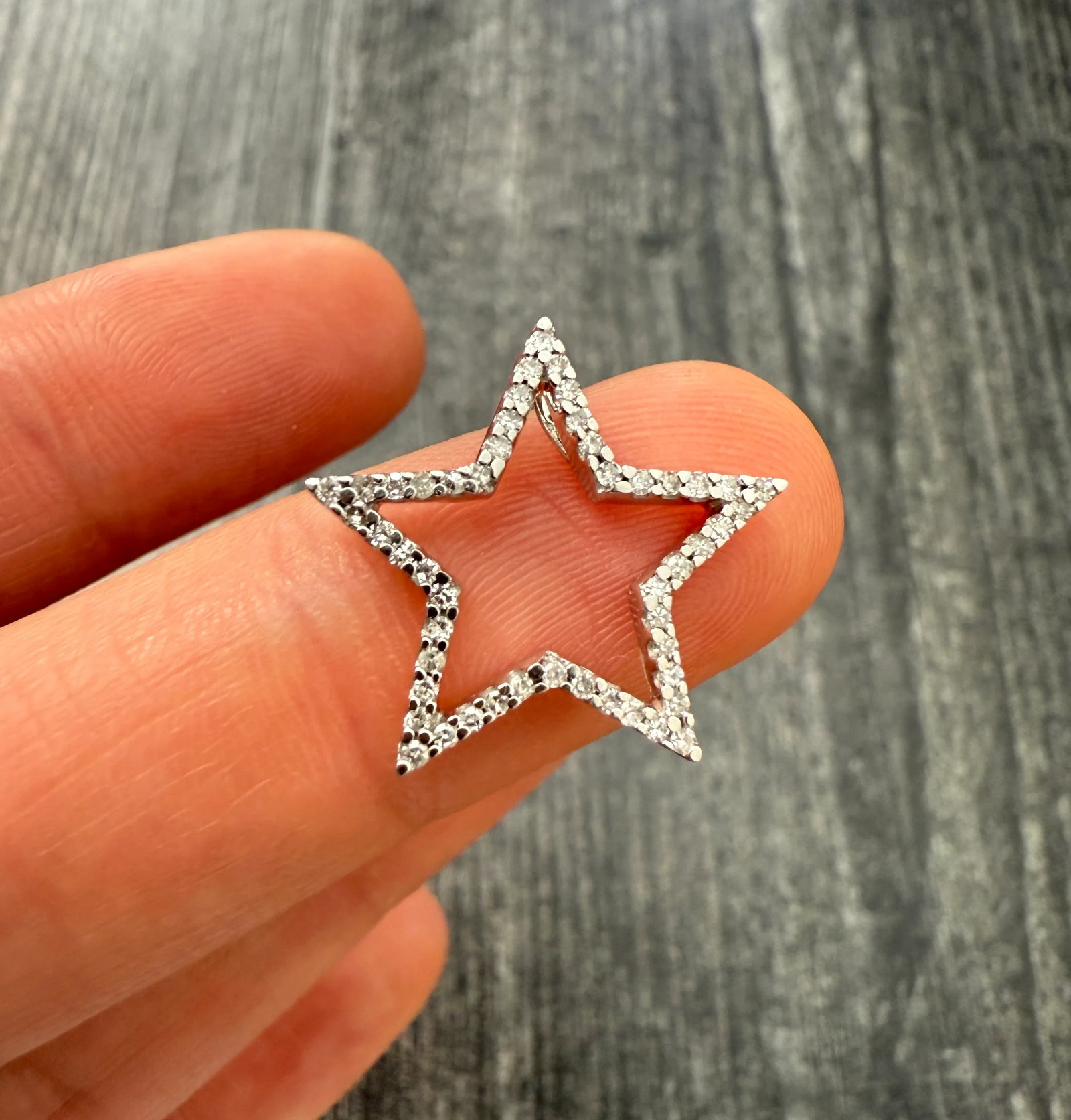 Diamond and 14K Gold Star Charm: Metal: 14K White Gold Weight: 2 gramsMeasurements: 0.75 inches long by 0.75 inches wideDiamond: Approximately 0.17 caratsMarkings: "BH 14K"Condition: In very good condition with some minor surface wea