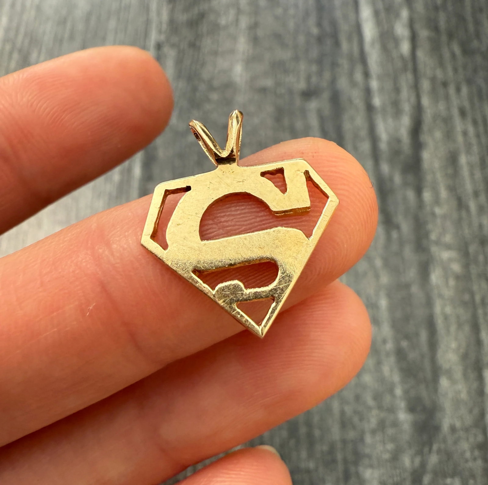 Vintage 14K Gold "SUPERMAN" Charm: Metal: 14K Yellow Gold Weight: 1.4 gramsMeasurements: 0.65 inches long by 0.55 inches wideMarkings: "14K"Condition: In very good condition with some minor surface wear consistent with age. Follow us o