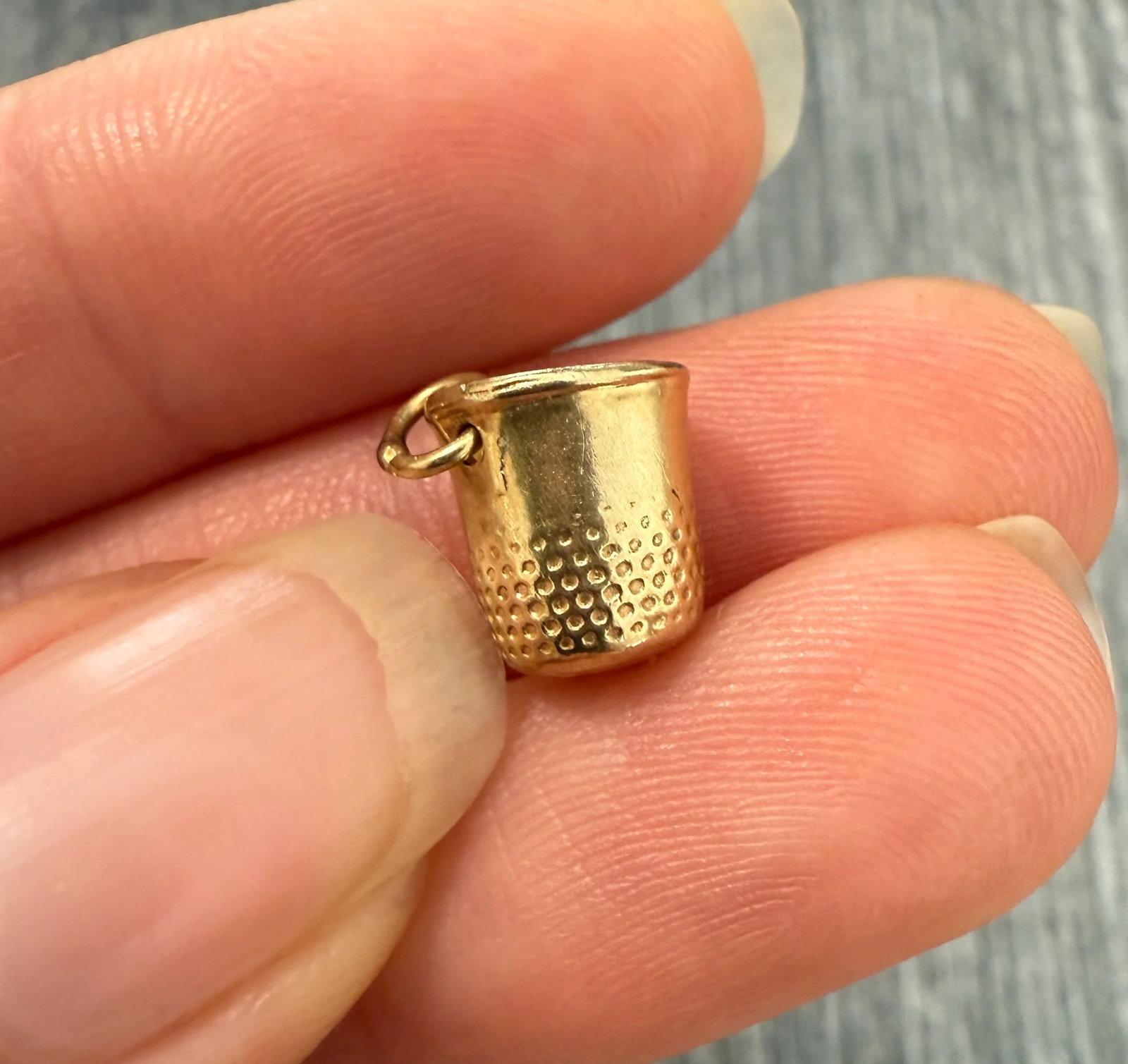 Vintage 14K Gold Thimble Sewing Charm: Metal: 14K Yellow Gold Weight: 1.6 gramsMeasurements: 0.4 inches long by 0.3 inches wideMarkings: "14K"Condition: In very good condition with some minor surface wear consistent with age. Follow us on 