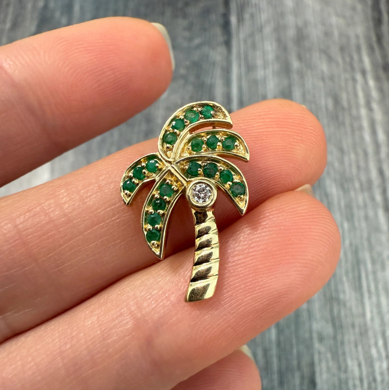 Diamond and 14K Gold Green Tropical Palm Tree Charm: Metal: 14K Yellow Gold Weight: 1.8 gramsMeasurements: 0.95 inches long by 0.55 inches wideDiamonds: Approximately 0.03 caratsMarkings: "14K CE"Condition: In very good condition with some minor surface