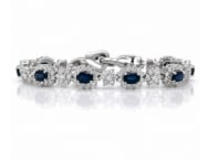 18K White Gold Sapphire & Diamond Bracelet: Elegant line bracelet styled in 18K white gold, set with alternating fine blue sapphires and sparkling diamonds.