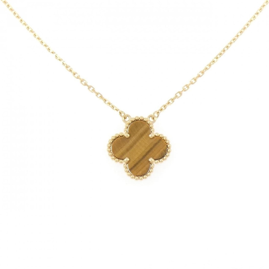 Van Cleef & Arpels Vintage Alhambra Necklace: --- Catalog ---Category: SizePendant Size: 14.9mm x 14.9mm / 0.58'' x 0.58''Neck Circumference: 42 cm - 47 cm / 16.53'' - 18.5''Category: DesignColor: Yellow goldStone: Tiger's eyeGender: