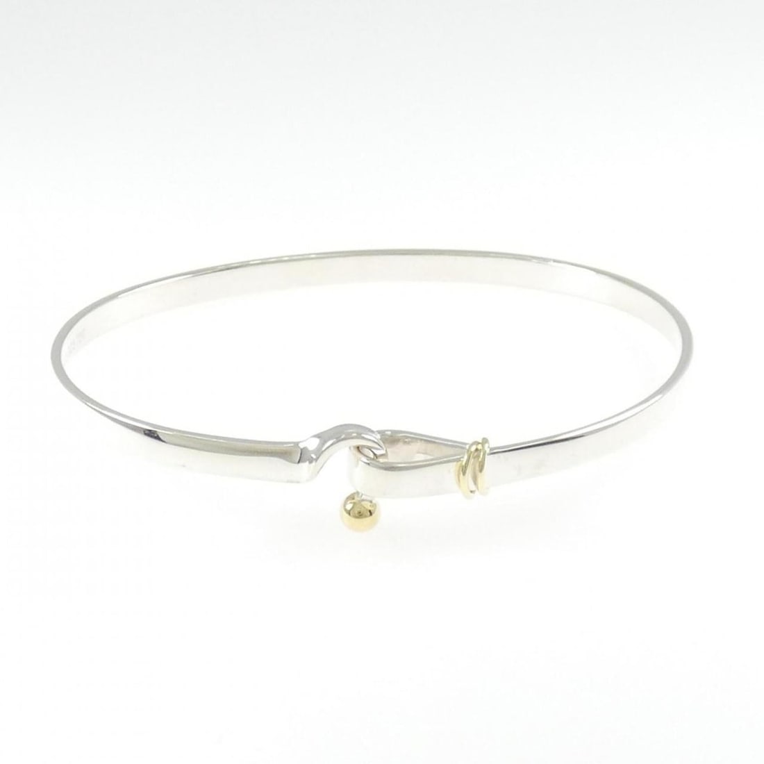 Tiffany Hook & Eye Bangle: --- Catalog ---Category: SizeLength: 17.5cm / 6.88''Category: DesignType: BangleGender: WomenMaterial: Silver 925, Yellow gold (18K)Category: GeneralBrand: Tiffany--- Item List ---Section: