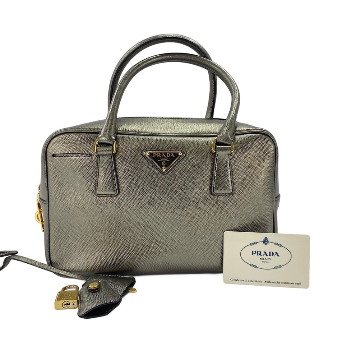 Prada Saffiano Handbag, Gold: --- Catalog ---Category: SizeHandle Drop: 11.00cm / 4.33''Size (HxWxD): 16cm x 25cm x 9.5cm / 6.29'' x 9.84'' x 3.74''Category: DesignType: HandbagColor: GoldGender: WomenMaterial: Saffiano Category: 
