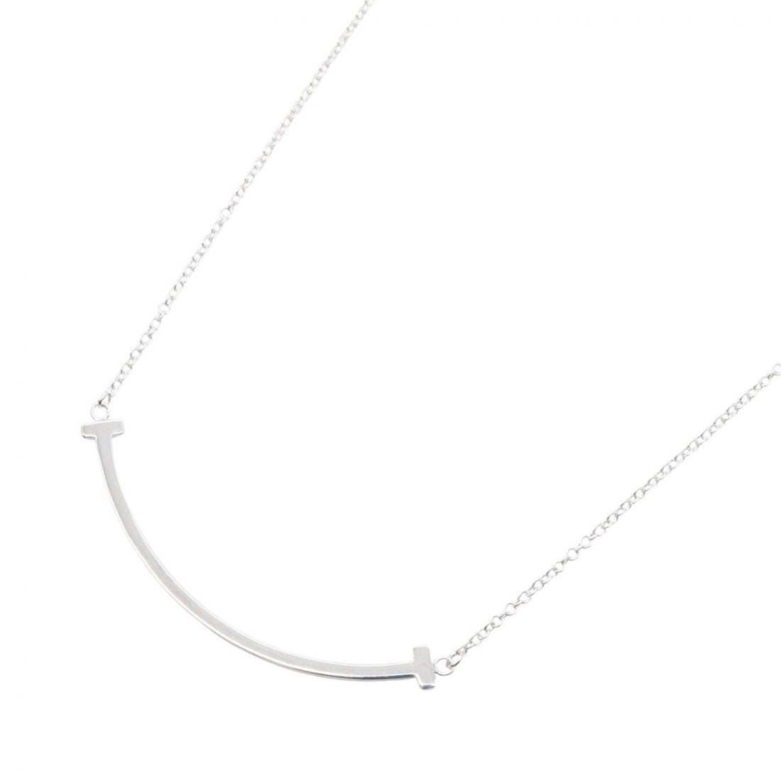 Tiffany & Co. T Smile Small Necklace, 18K White Gold (18KWG), Women's, Silver Tone, 60011677: --- Catalog ---Category: SizePendant Size: 3mm x 37mm / 0.11'' x 1.45''Neck Circumference: 40.5 cm - 45.5 cm / 15.94'' - 17.91''Category: DesignColor: SilverGender: WomenMaterial: White gold (18K)Neck