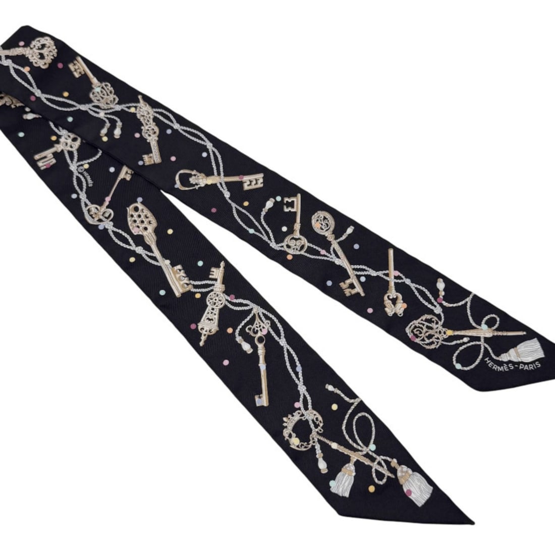 HERMES Twilly Les Cles a Pois Silk Noir Black Women's Scarf/Muffler: --- Catalog ---Category: SizeSize (LxW): 85cm x 5cm / 33.46'' x 1.96''Category: DesignType: ScarfColor: BlackGender: WomenMaterial: Silk Category: GeneralBrand: Hermes--- Item List ---Section: Conditi