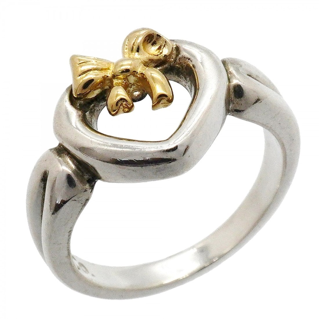 Tiffany & Co. Heart Ribbon Ring, 18K Yellow Gold (KYG), Sterling Silver 925, Size 7.5, Women's: --- Catalog ---Category: SizeJP Size: 7.5US Size: 4Category: DesignType: Band ringGender: WomenMaterial: Silver 925, Yellow gold (18K)Category: GeneralBrand: Tiffany--- Item List ---Section: Condition