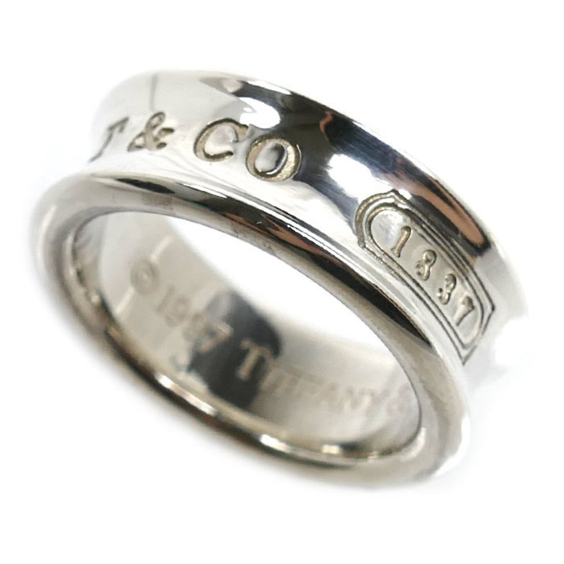 TIFFANY&Co. Tiffany & Co. Sterling Silver 925 1837 Ring, 6.9g, Women's: --- Catalog ---Category: SizeUS Size: 5Brand Size: 49.5Category: DesignType: Band ringGender: WomenMaterial: Silver 925Category: GeneralBrand: TiffanyCountry of Origin: USA--- Item List ---Section: Co