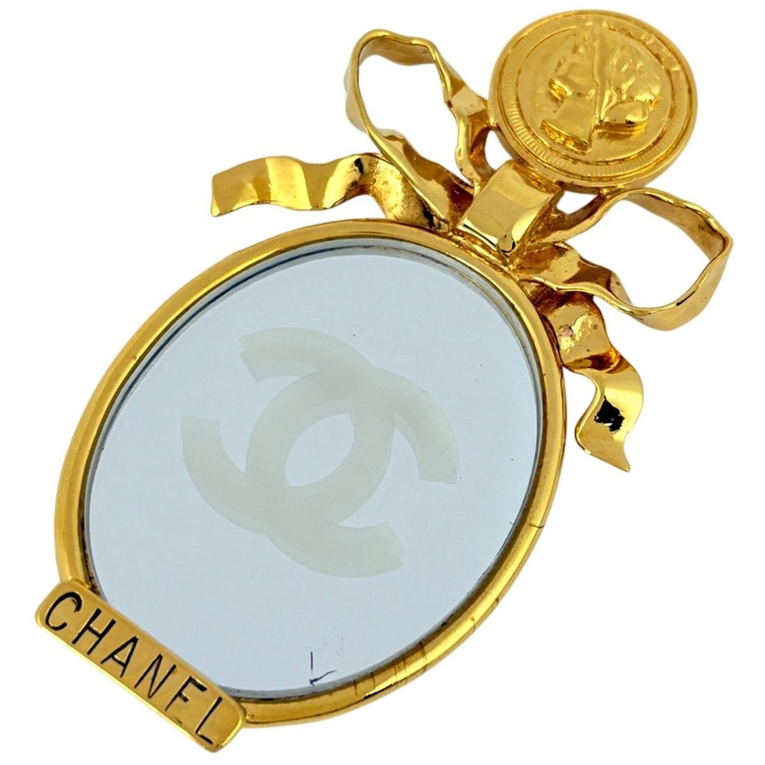 Chanel Coco Mark Mirror Brooch Logo Ribbon GP Gold Women's: --- Catalog ---Category: SizeSize (HxWxD): 9.2cm x 5.5cm / 3.62'' x 2.16''Category: DesignType: BroochColor: GoldGender: WomenMaterial: Gold platingCategory: GeneralBrand: Chanel--- Item List ---Secti