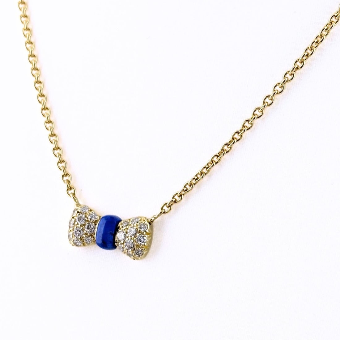Van Cleef & Arpels Ribbon Motif Necklace, Yellow Gold (YG), with Small Diamonds and Lapis Lazuli,: --- Catalog ---Category: SizePendant Size: 7.2mm x 15mm / 0.28'' x 0.59''Neck Circumference: 39.5 cm / 15.55''Category: DesignGender: WomenMaterial: Yellow gold (18K)Necklace Type: NecklaceCategory: G