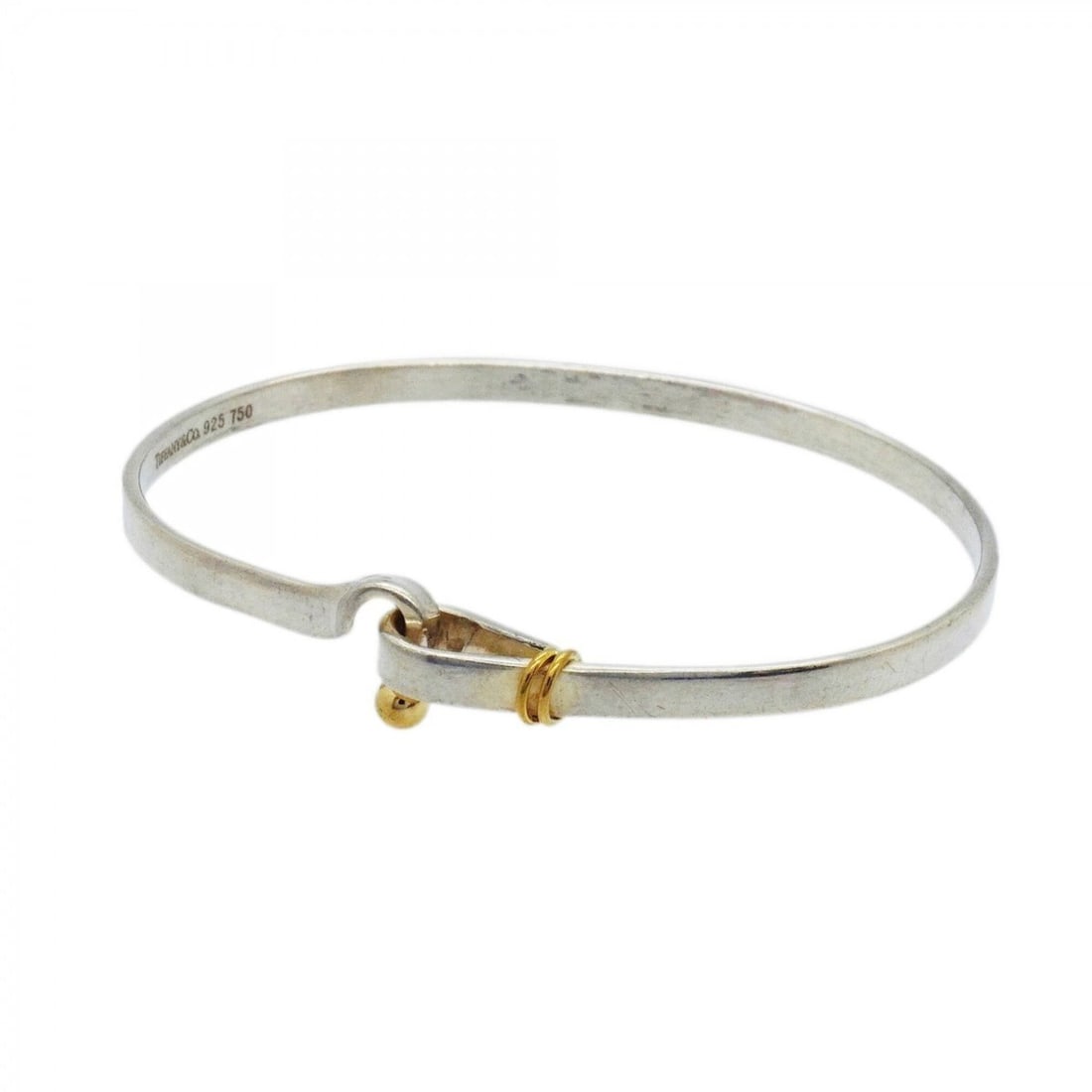 Tiffany & Co. Hook Eye Bangle, 18K Yellow Gold (KYG), Sterling Silver 925, for Men and Women: --- Catalog ---Category: SizeLength: 17.5cm / 6.88''Category: DesignType: BangleGender: Men,WomenMaterial: Silver 925, Yellow gold (18K)Category: GeneralBrand: Tiffany--- Item List ---Section: Conditi