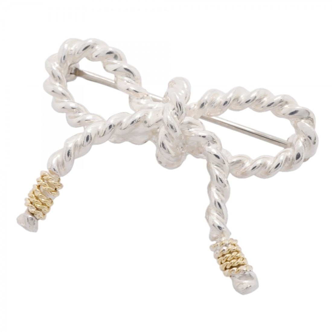 Tiffany & Co. Ribbon Brooch, 18K Yellow Gold (KYG), Sterling Silver (925), Women's.: --- Catalog ---Category: SizeSize (HxWxD): 2.29cm x 3.17cm / 0.9'' x 1.24''Category: DesignType: BroochGender: WomenMaterial: Silver 925, Yellow gold (18K)Category: GeneralBrand: Tiffany--- Item List 