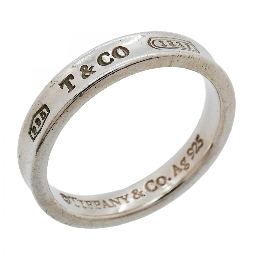 Tiffany & Co. Narrow Ring, Sterling Silver 925, Size 17.5 (Women's): --- Catalog ---Category: SizeJP Size: 17.5US Size: 8.5Category: DesignType: Band ringGender: WomenMaterial: Silver 925Category: GeneralBrand: Tiffany--- Item List ---Section: ConditionRanking: Rank AB