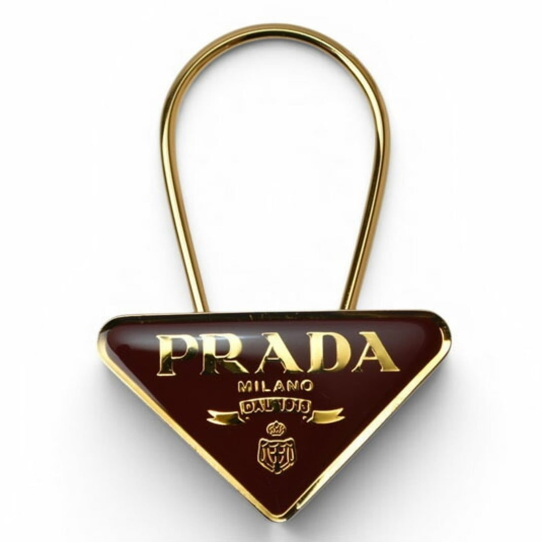 Prada Keyring/Keychain PRADA Triangle Bordeaux/Gold M285: --- Catalog ---Category: SizeSize (HxWxD): 7cm x 5cm / 2.75'' x 1.96''Category: DesignType: KeyringColor: BordeauxGender: Unisex,Men,WomenMaterial: MetalCategory: GeneralBrand: Prada--- Item List ---S
