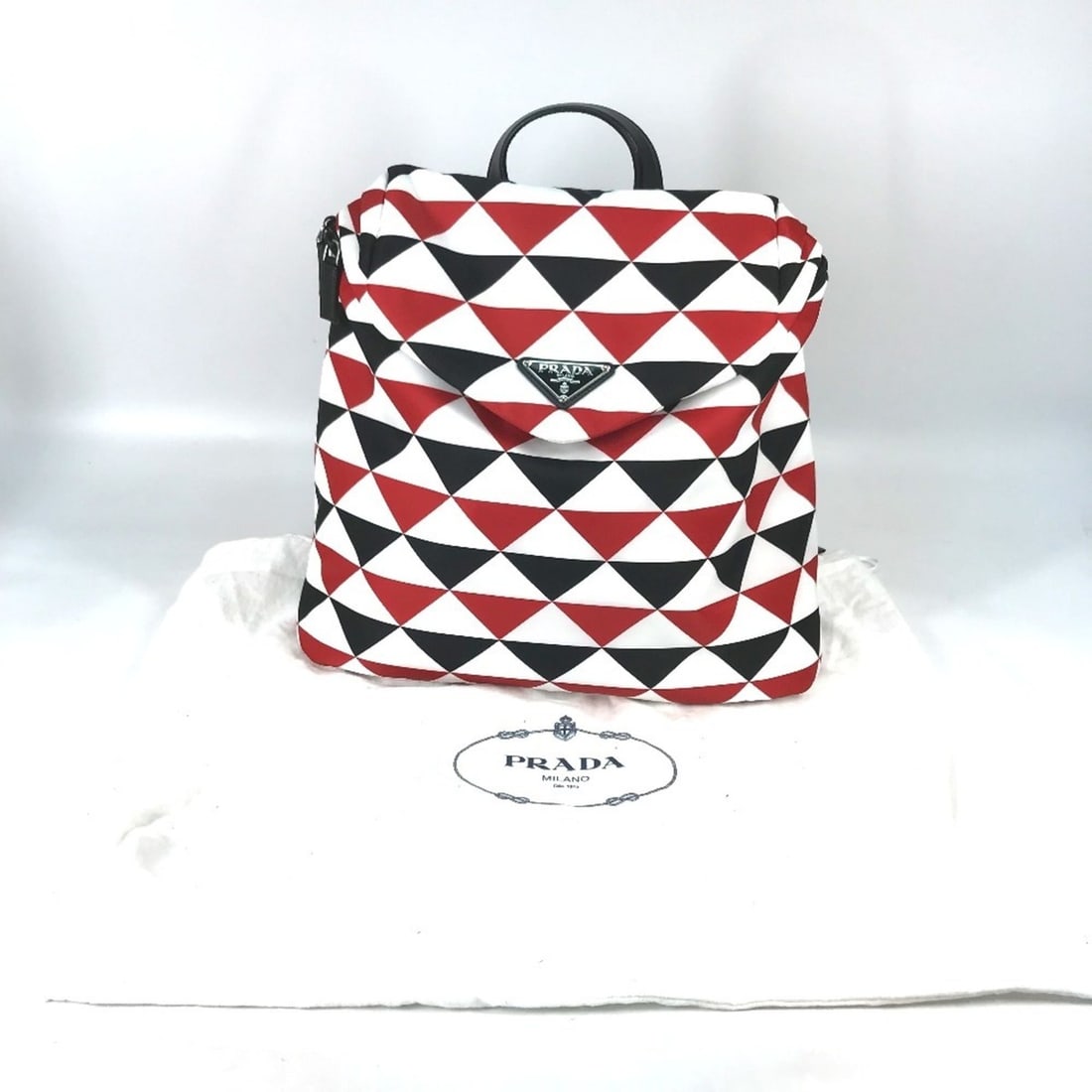 PRADA Prada Triangle Plate Signo Print Backpack Nylon Men's Red E-231215-29: --- Catalog ---Category: SizeSize (HxWxD): 36.5cm x 39cm x 12cm / 14.37'' x 15.35'' x 4.72''Category: DesignType: BackpackColor: Black, Red color, WhiteGender: Men,WomenClosure: ZipperMaterial: Nylon 