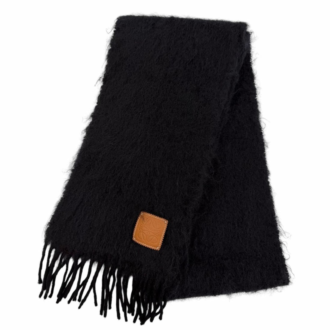 LOEWE Mohair Wool Anagram Leather Patch Fringe Stole Scarf, Black, Made in Spain, Authentic, Women's: --- Catalog ---Category: SizeSize (LxW): 1.82m x 23cm / 71.65'' x 9.05''Category: DesignType: StoleColor: BlackGender: WomenMaterial: Mohair , Wool , Nylon Category: GeneralBrand: LoeweCountry of Orig