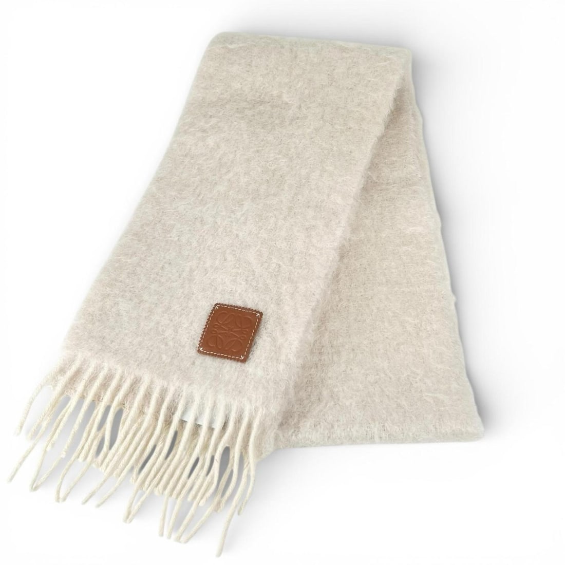 LOEWE Mohair Wool Anagram Leather Patch Fringe Stole/Scarf, White, Made in Spain, Authentic, Women's: --- Catalog ---Category: SizeSize (LxW): 1.84m x 21cm / 72.44'' x 8.26''Category: DesignType: StoleColor: WhiteGender: WomenMaterial: Mohair , Wool , Nylon Category: GeneralBrand: LoeweCountry of Orig