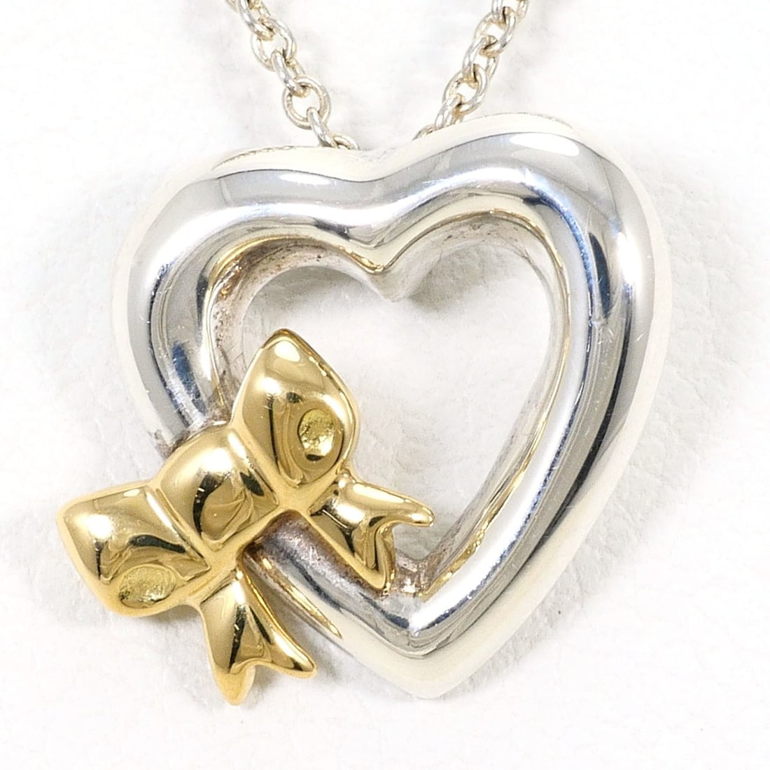 Tiffany & Co. Heart Ribbon 18K Yellow Gold Silver Necklace, Total Weight 2.7g, 46cm, Jewelry: --- Catalog ---Category: SizeWeight: 2.7g / 0.09oz.Pendant Size: 13mm x 13mm / 0.51'' x 0.51''Neck Circumference: 46 cm / 18.11''Category: DesignGender: WomenMaterial: Silver 925, Yellow gold